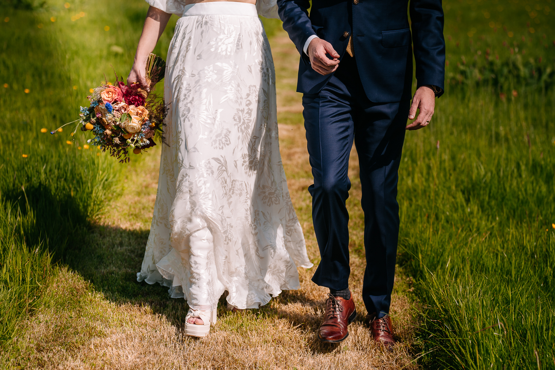 A man and woman holding hands in a field