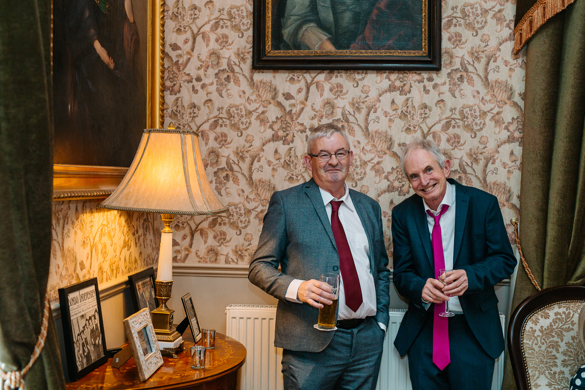 A couple of men holding glasses of beer