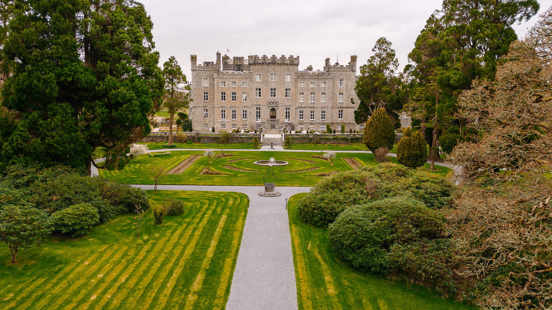 A large building with a green lawn