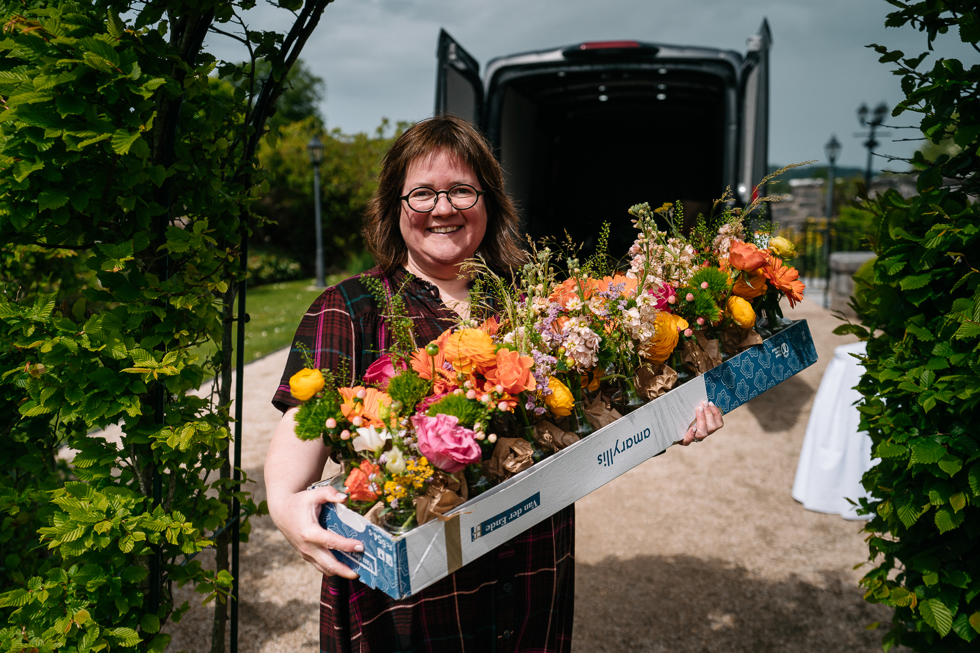 A person holding a box of flowers