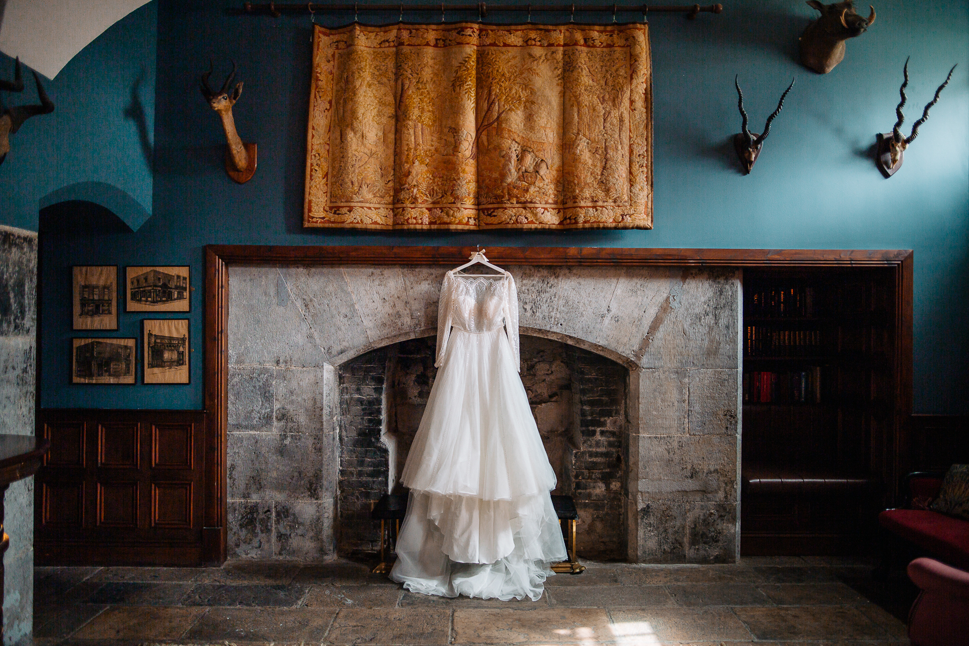 A person in a white dress in front of a fireplace