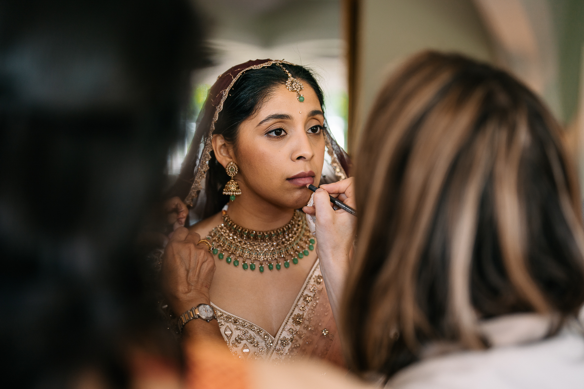 A woman with a green necklace