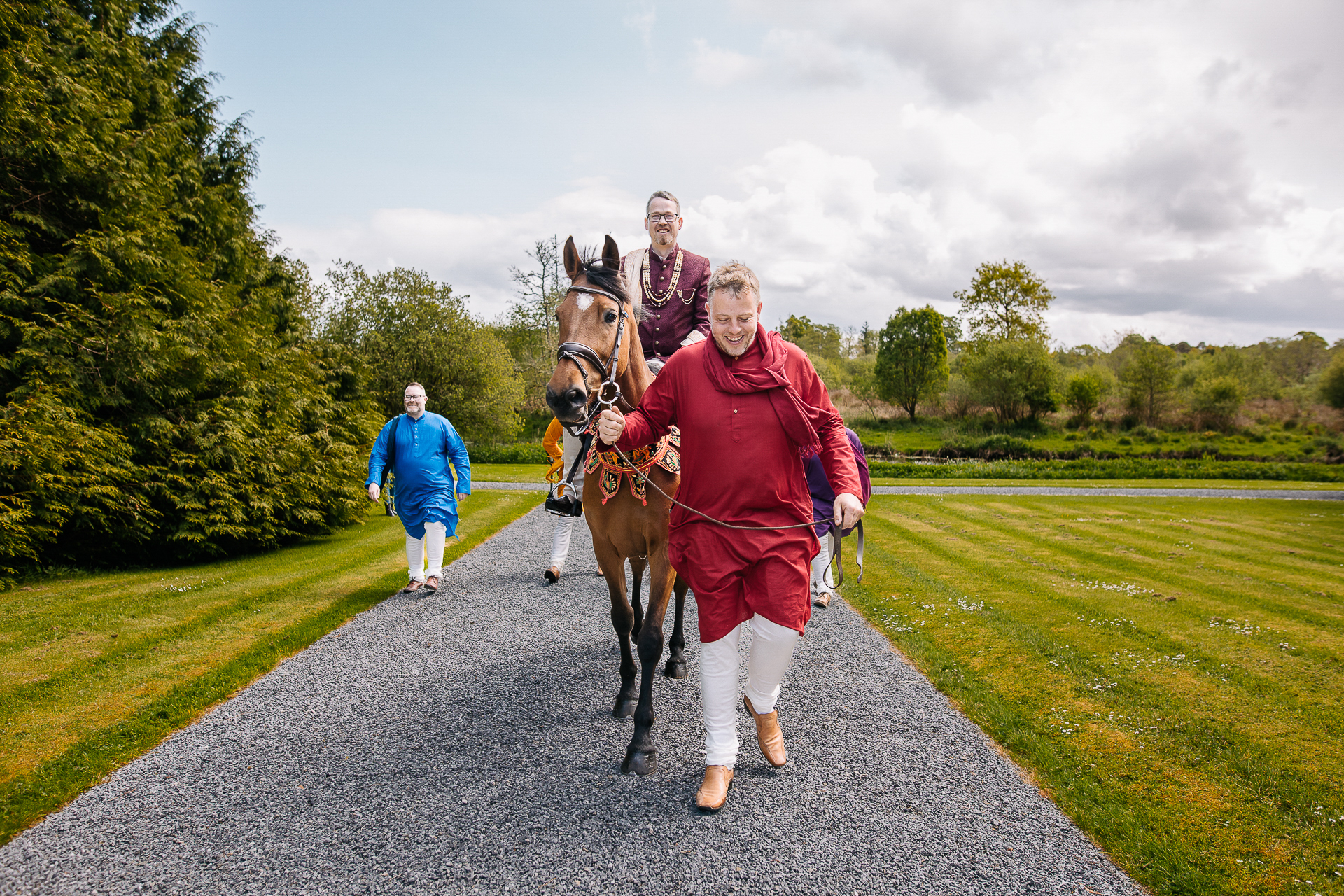 A group of people walking a horse