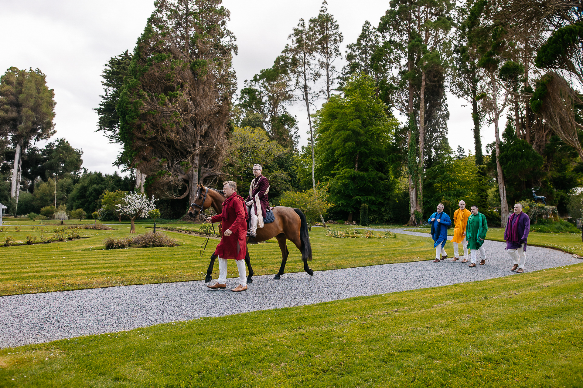 A group of people walking a horse