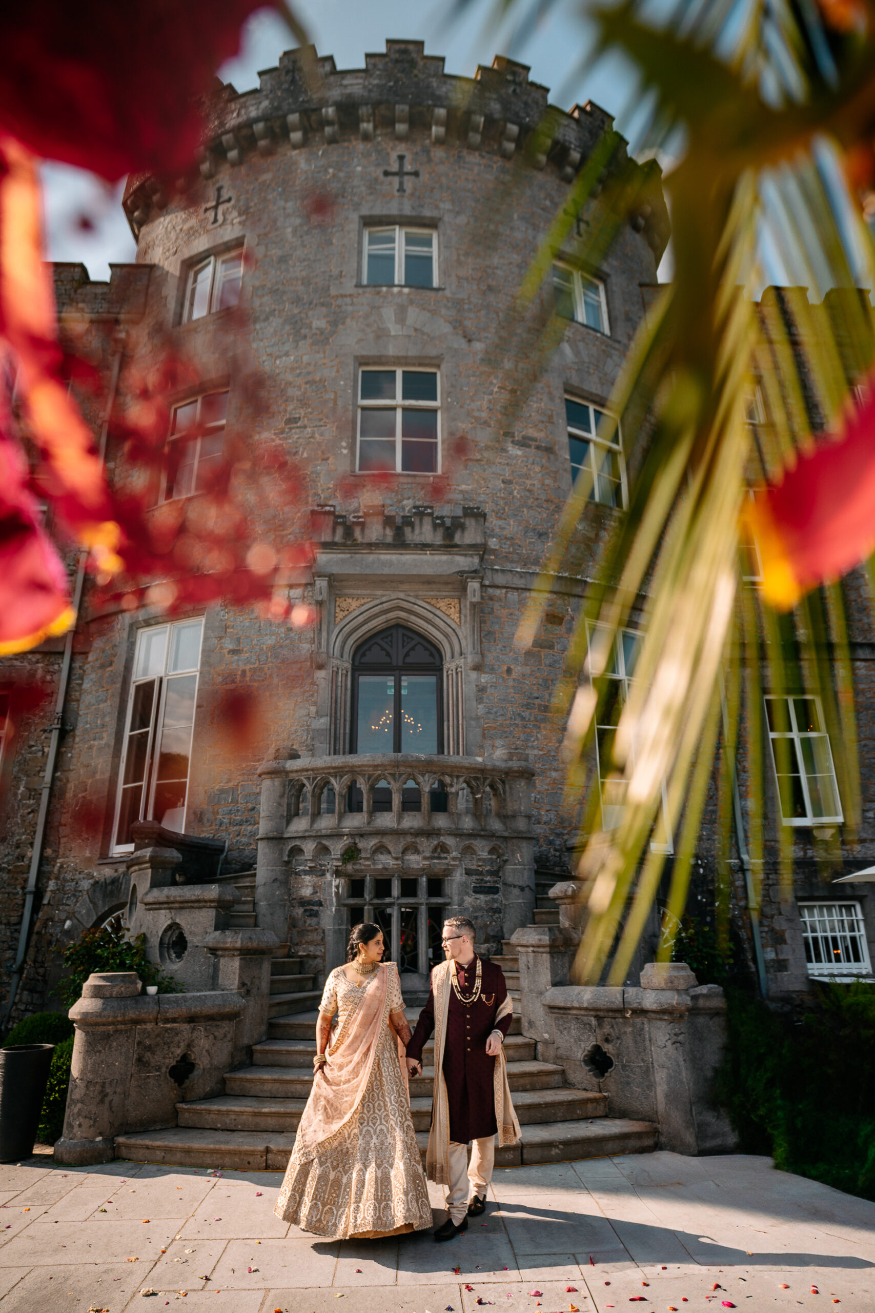 A man and woman posing for a picture in front of a building