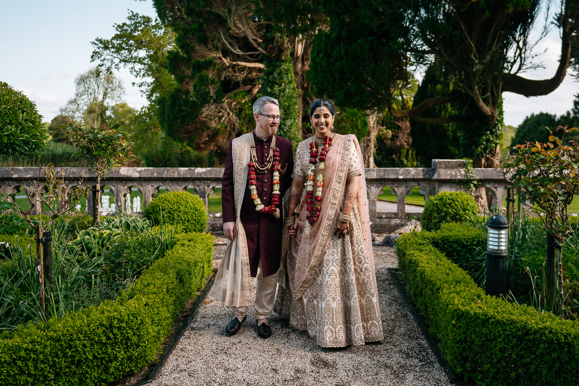 A man and woman posing for a picture in a garden