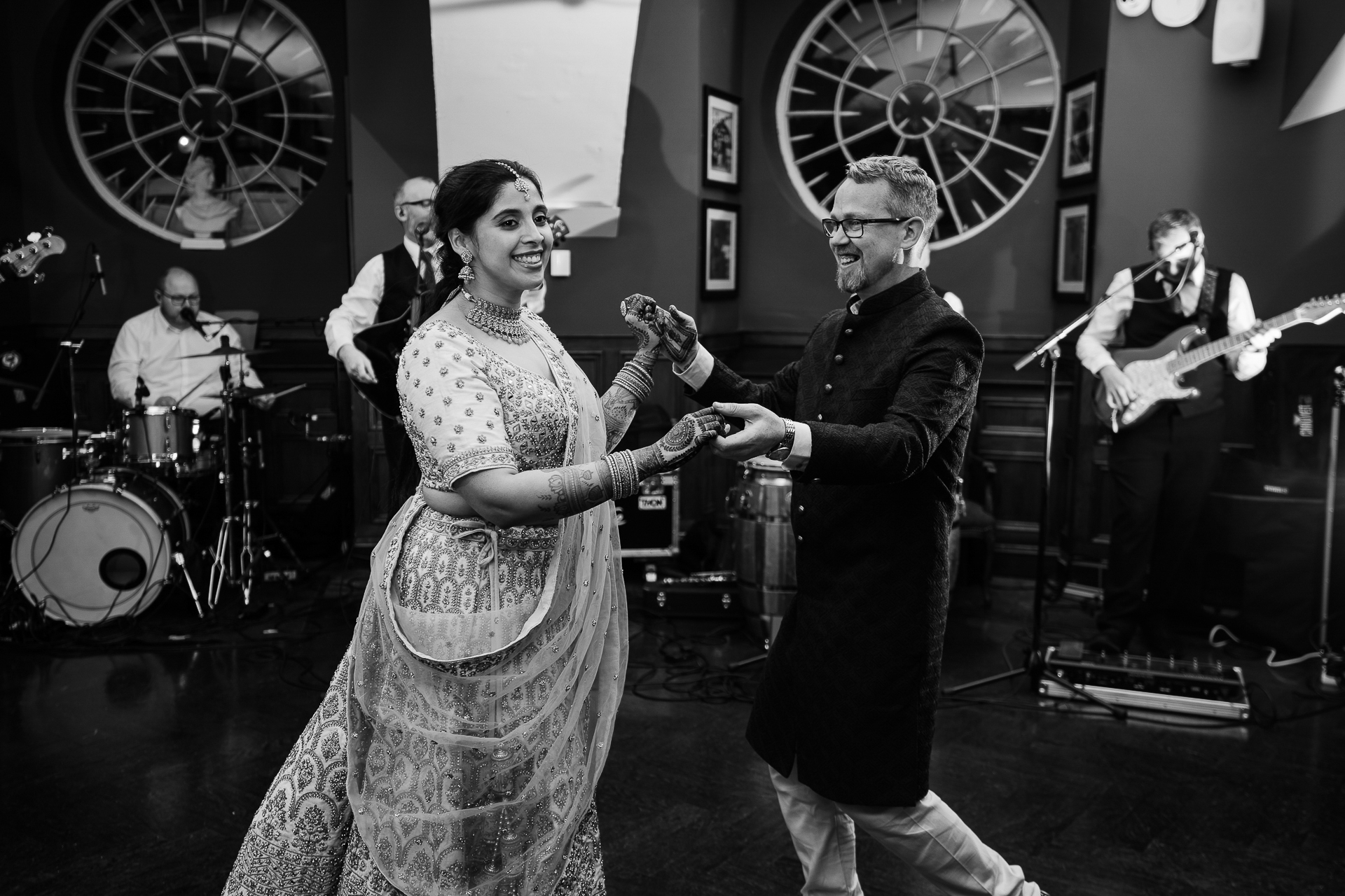 A man and woman dancing in front of a band playing instruments