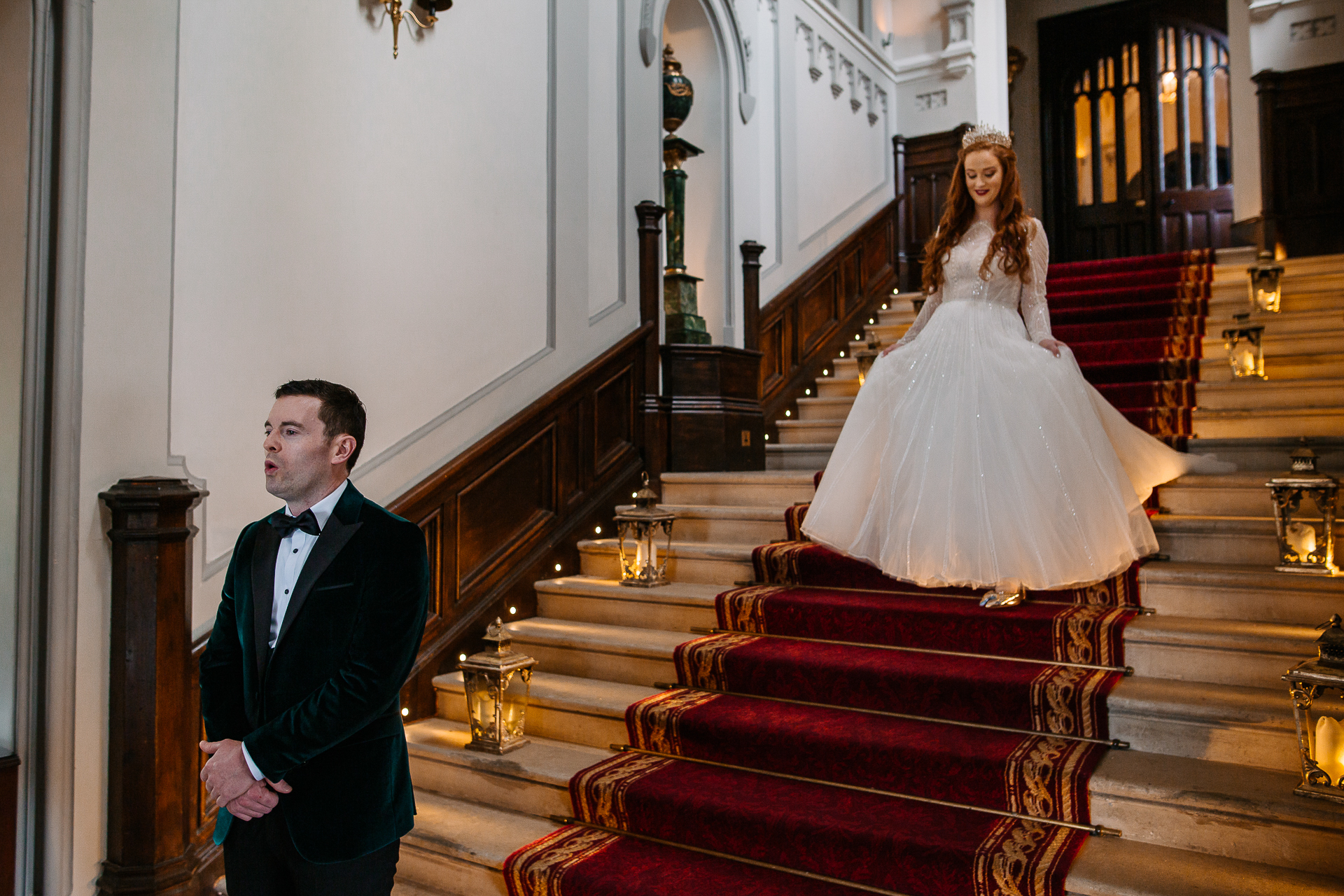 A man and woman in formal wear on a staircase