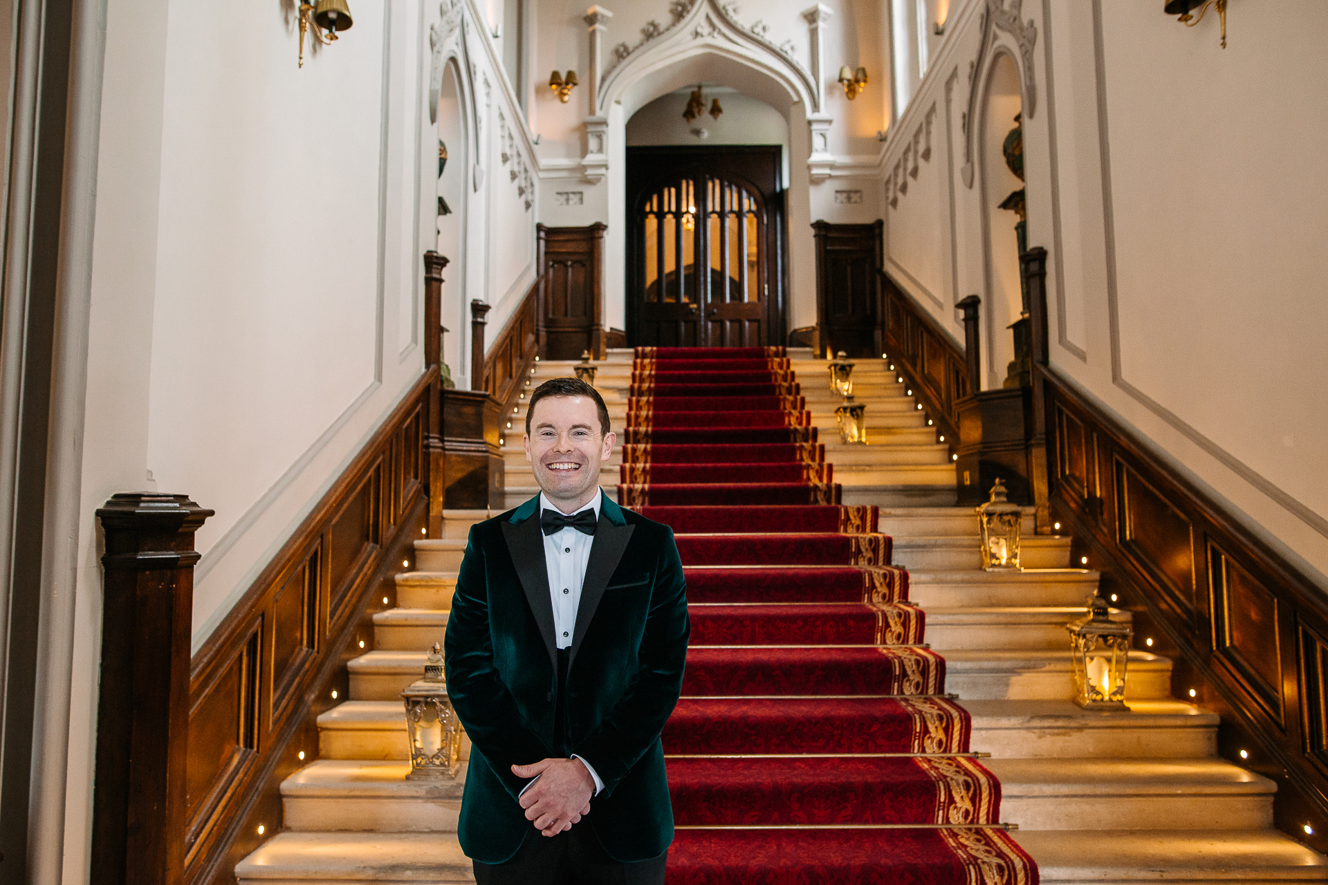 A person in a suit standing on a staircase