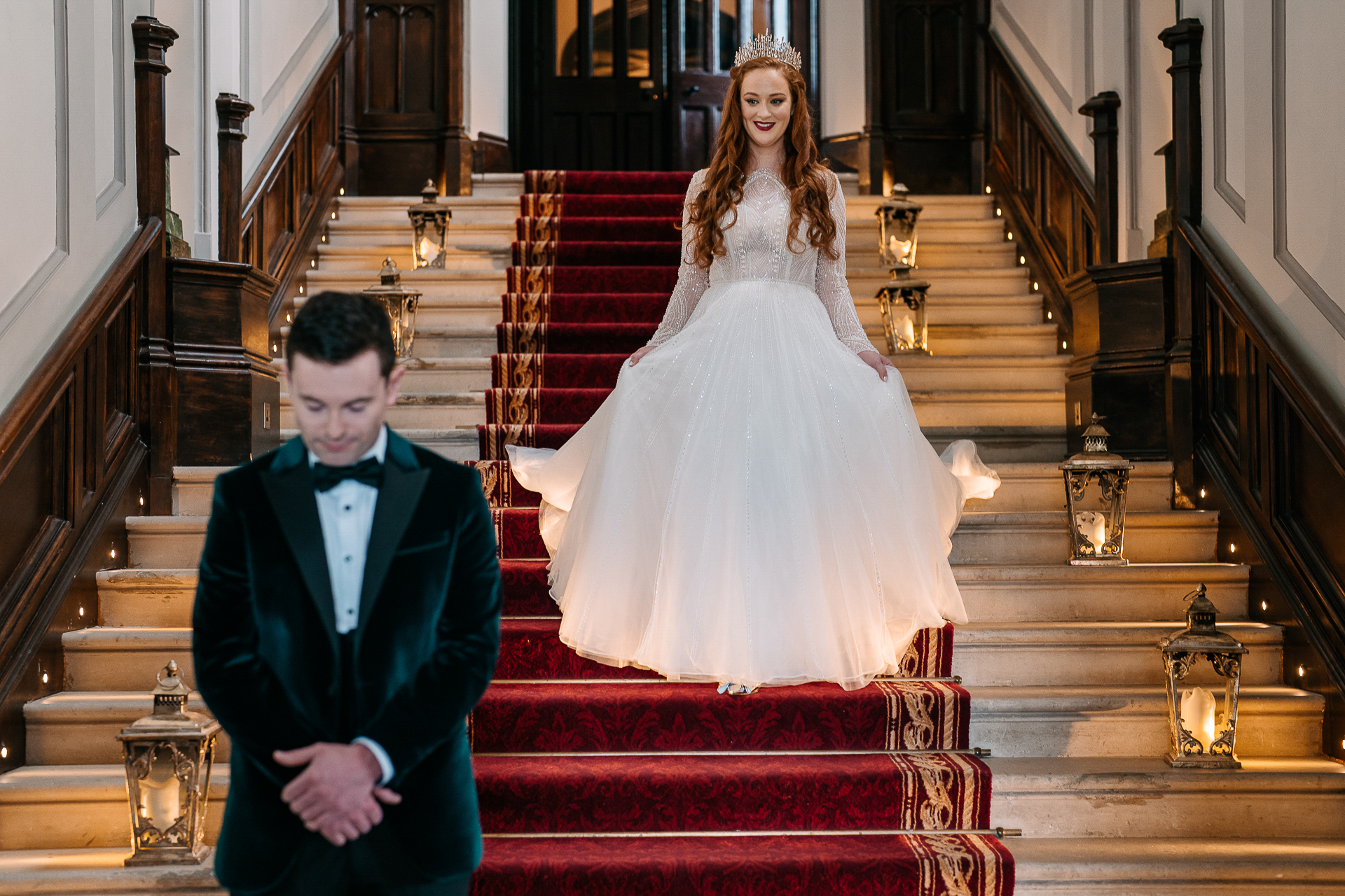 A man and woman posing for a picture on a staircase