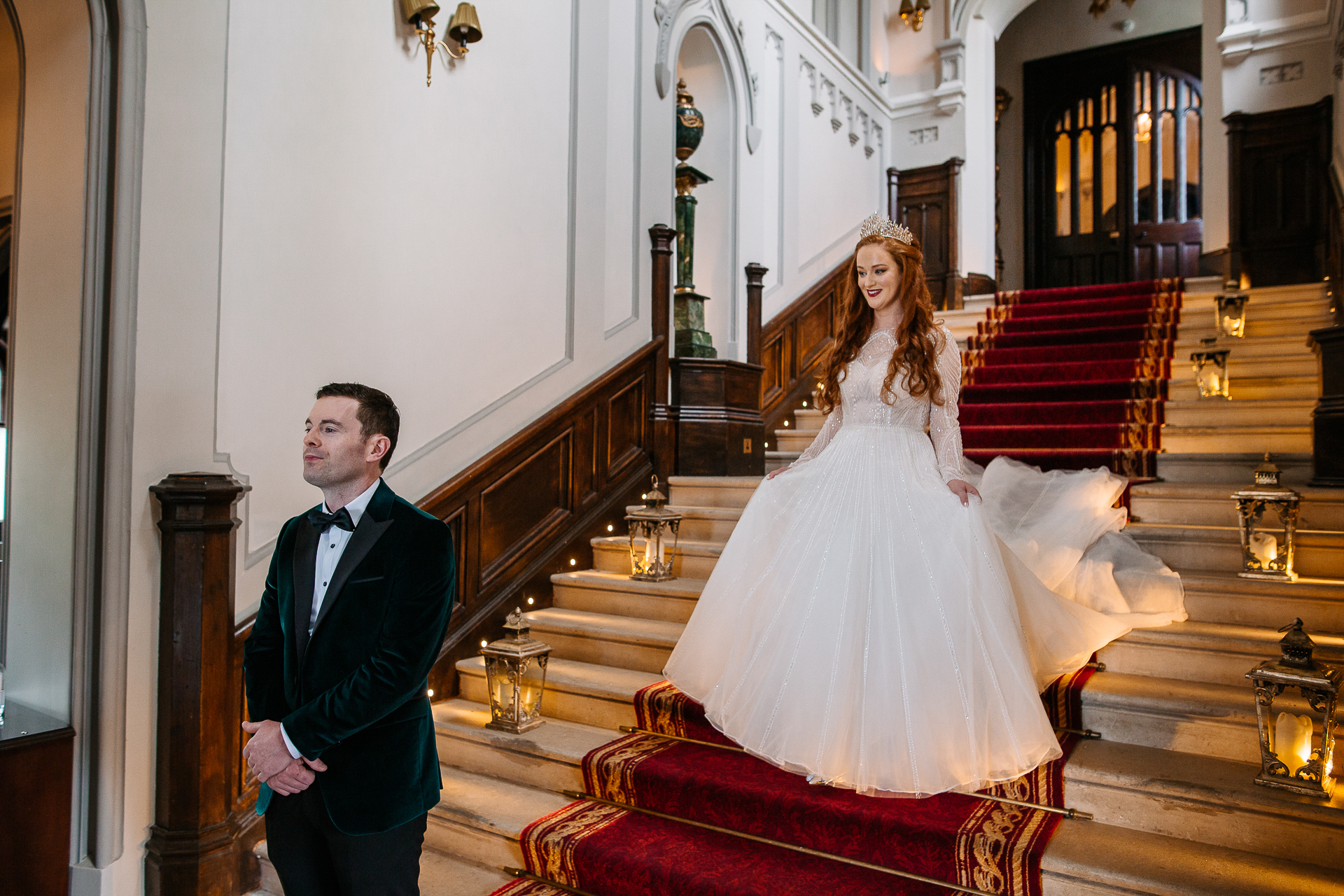 A man and woman in formal wear on stairs