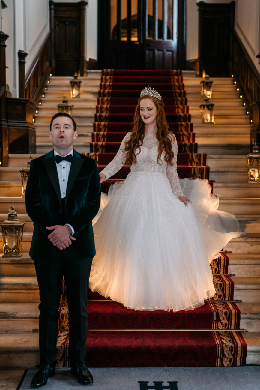 A man and woman posing for a picture on a staircase