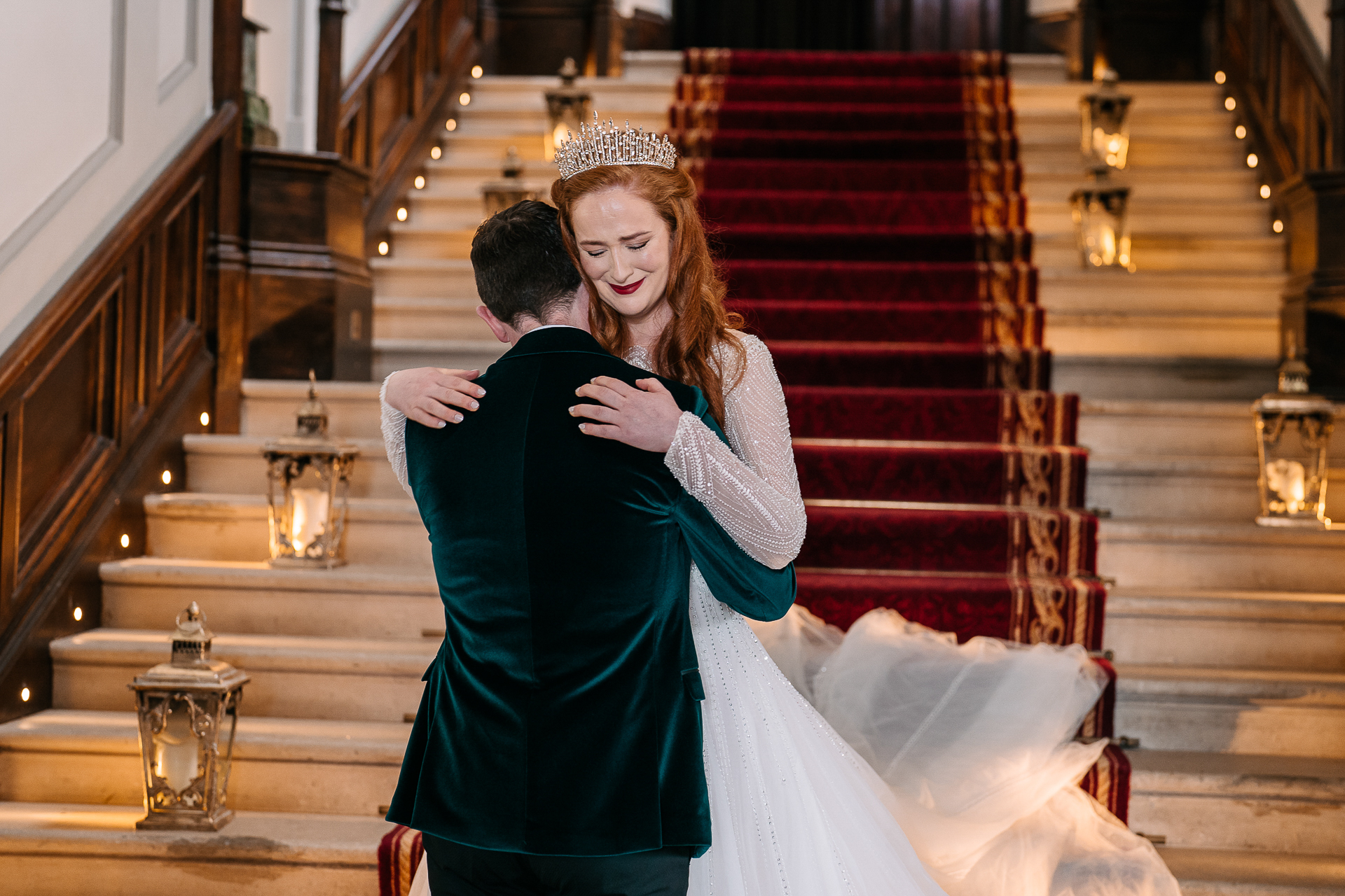 A man and woman hugging on a staircase