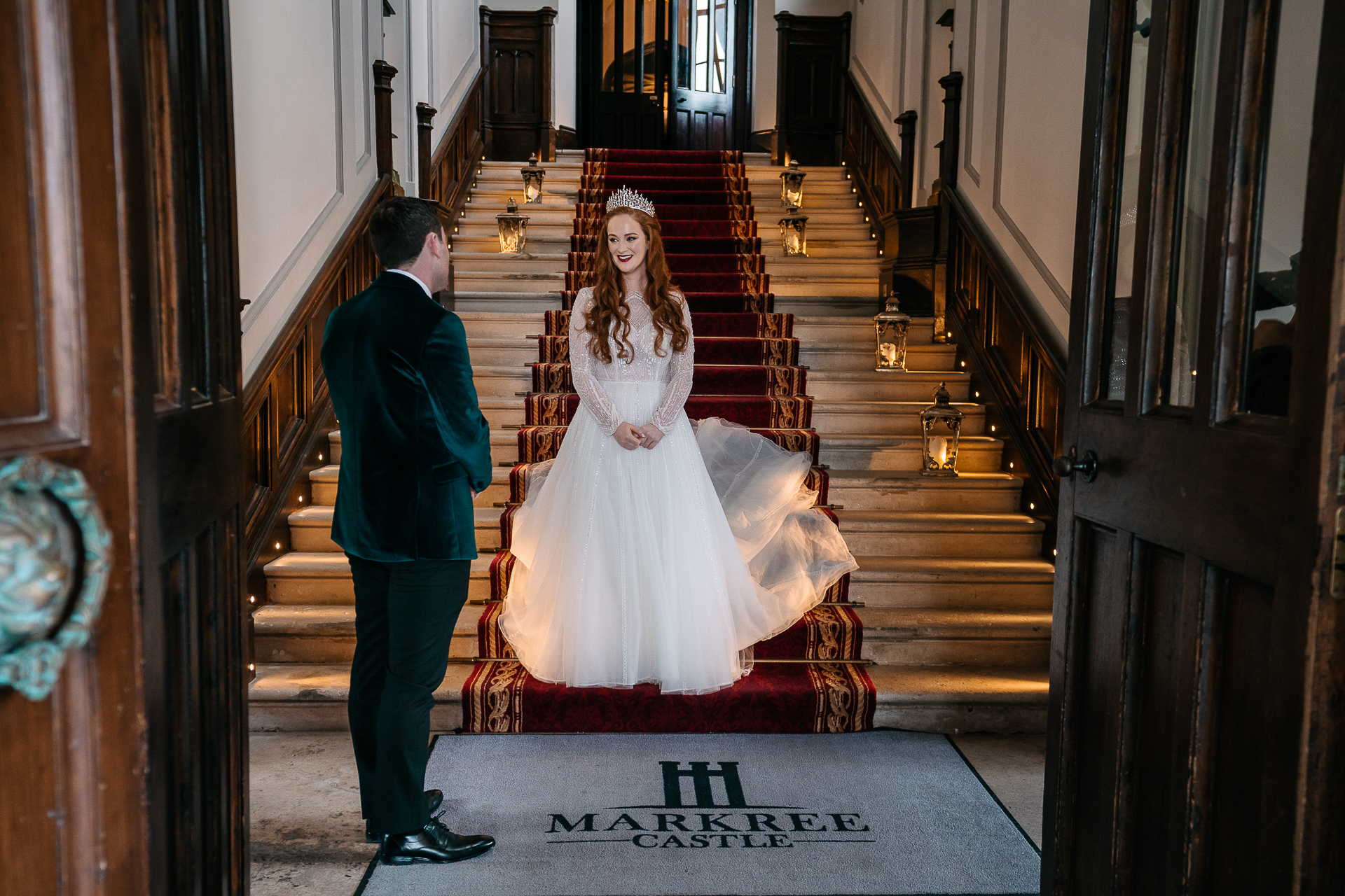 A man and woman in wedding attire on stairs