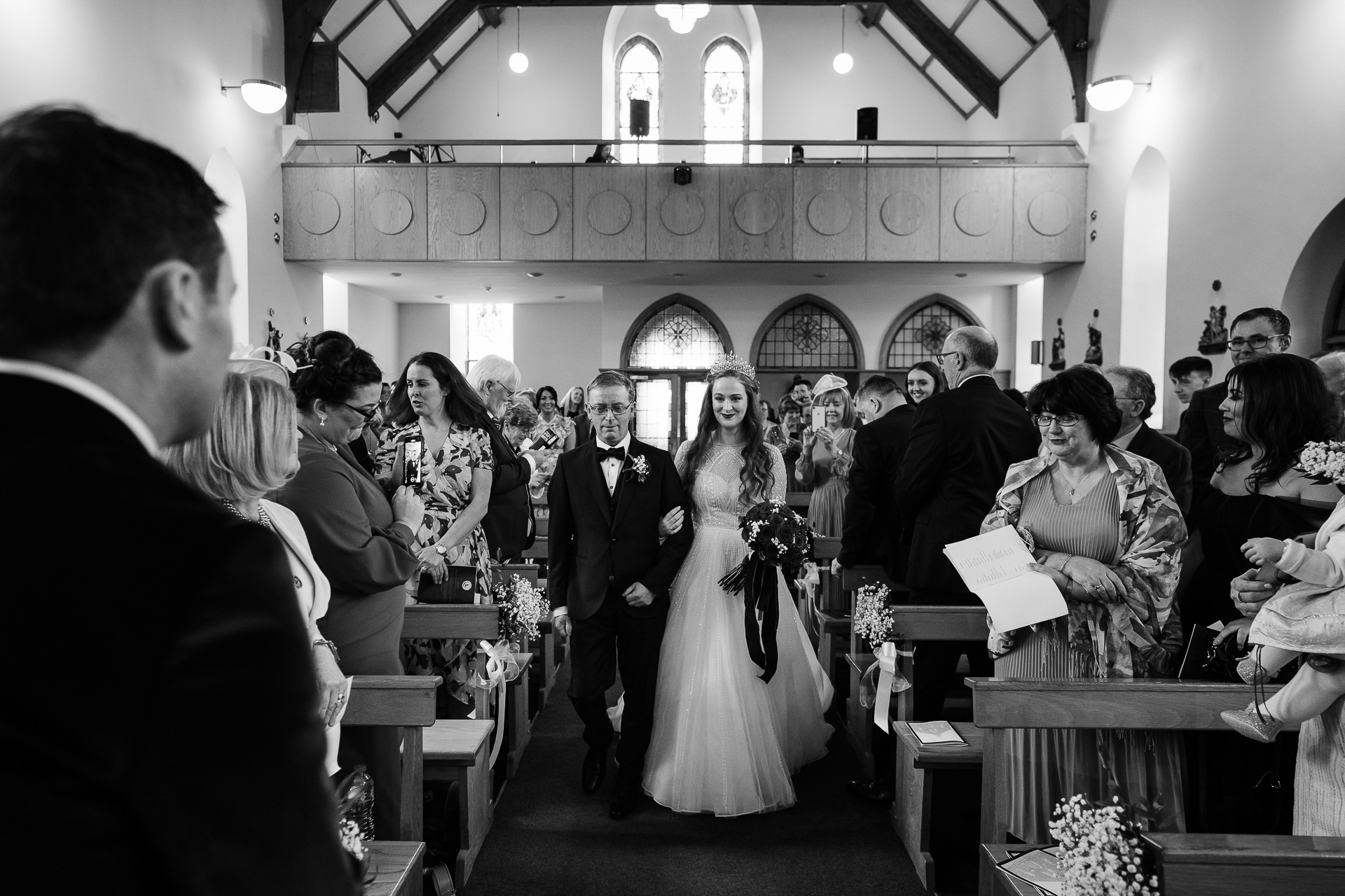 A bride and groom walking down the aisle