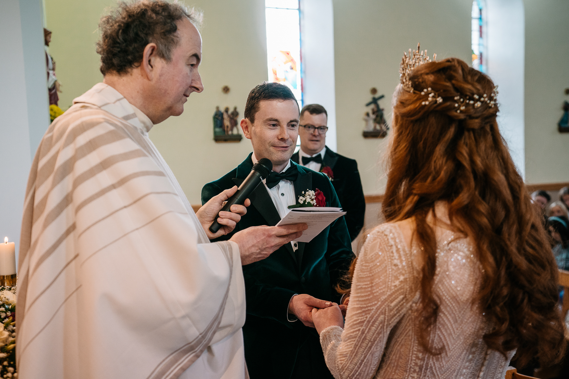 A man in a suit and a woman in a dress holding a book