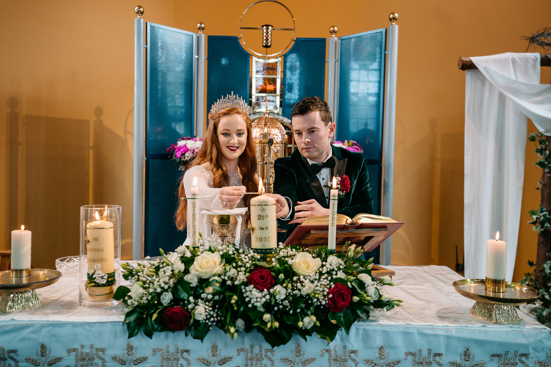 A man and a woman sitting at a table with flowers