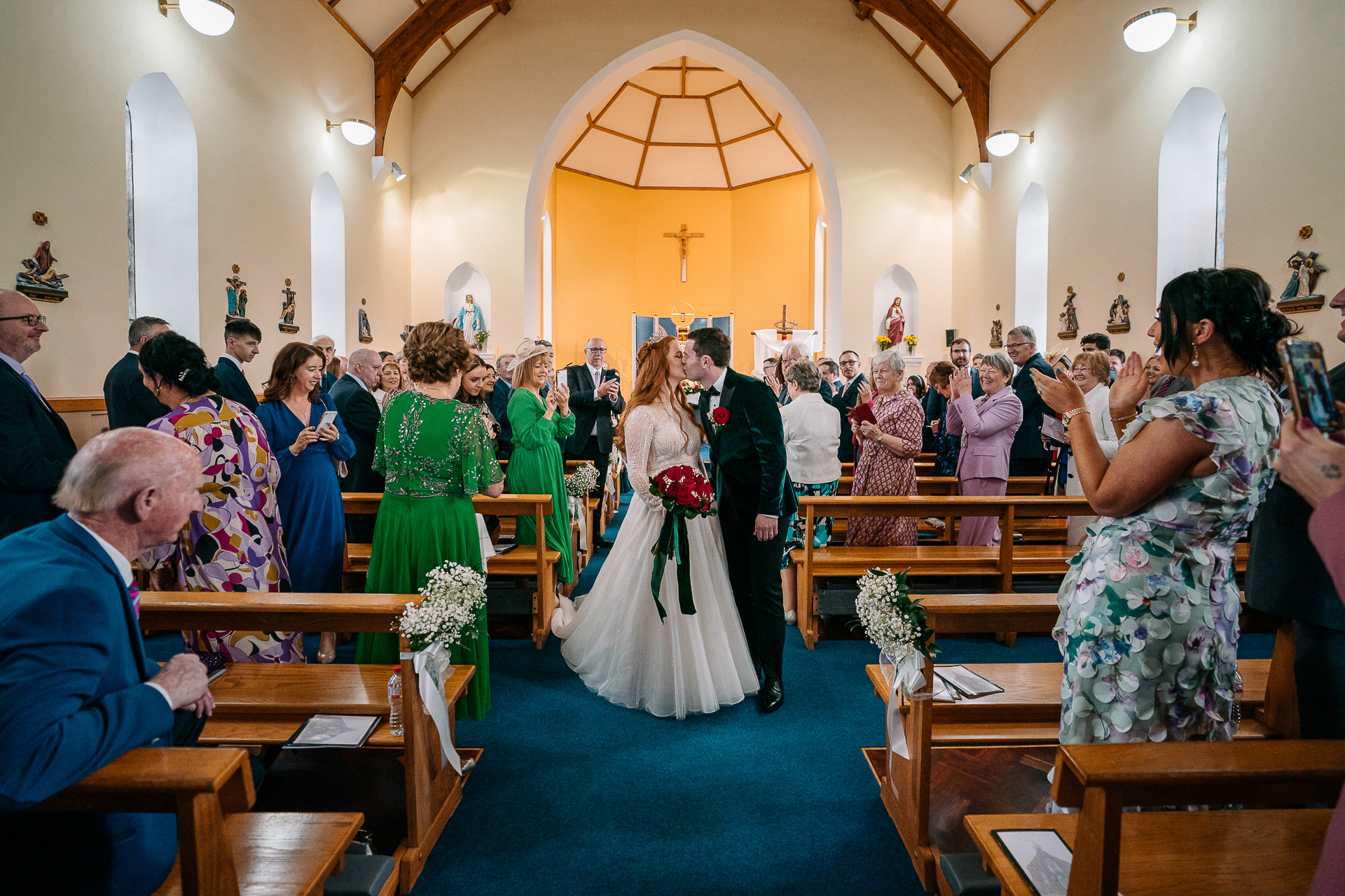 A bride and groom walking down the aisle