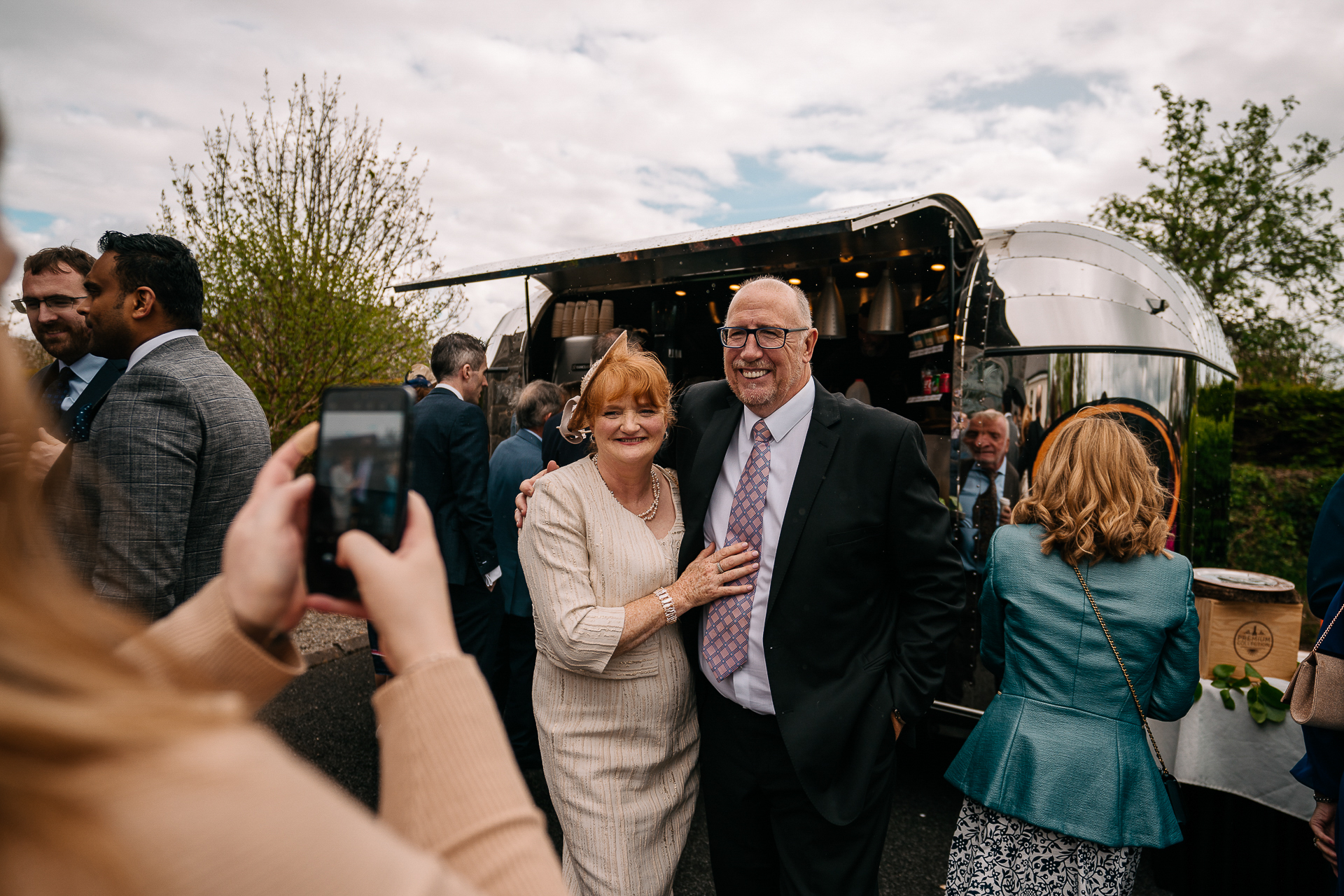 A man and woman taking a picture with a group of people