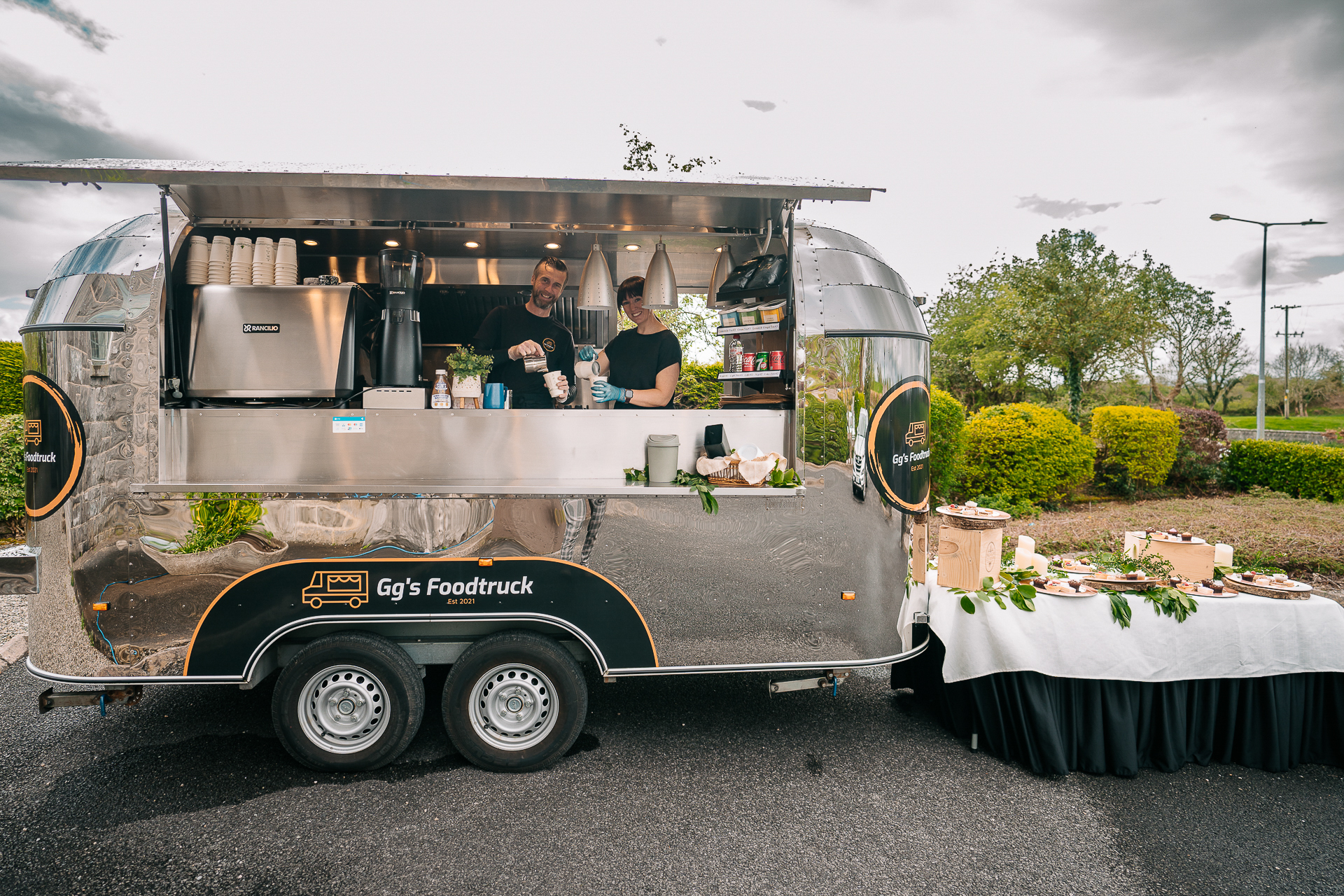 A group of people standing in a food truck