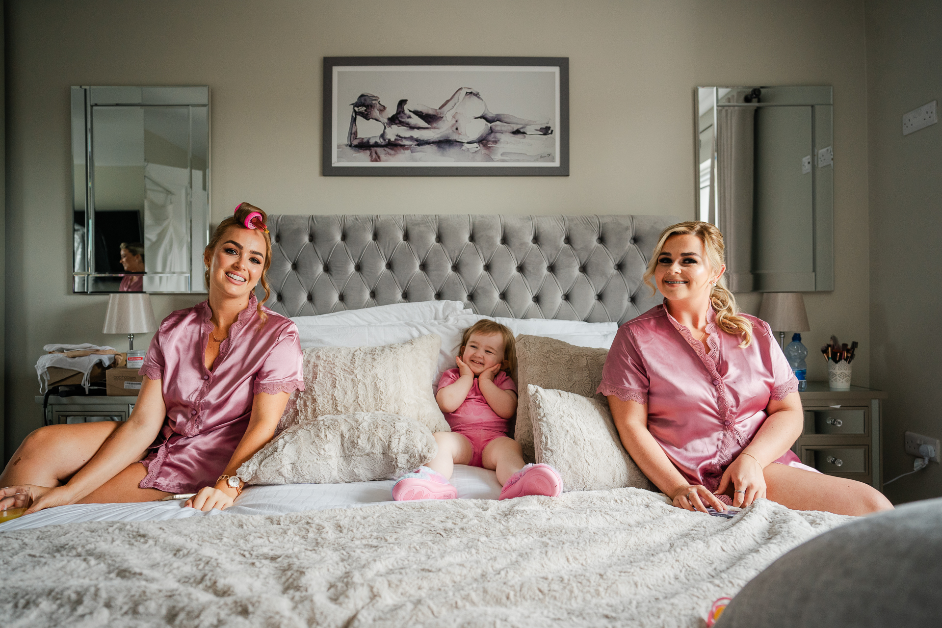 A group of women sitting on a bed