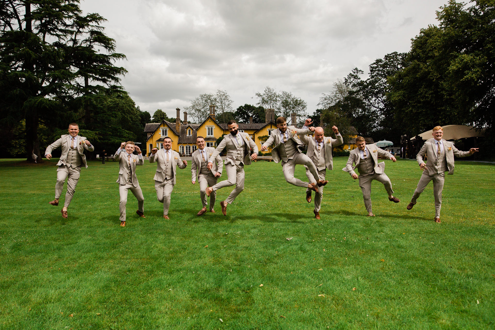 A group of men in military uniforms running on a grass field