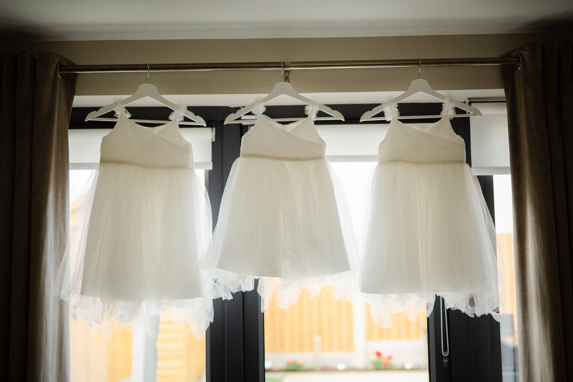 A couple of wedding dresses from a window