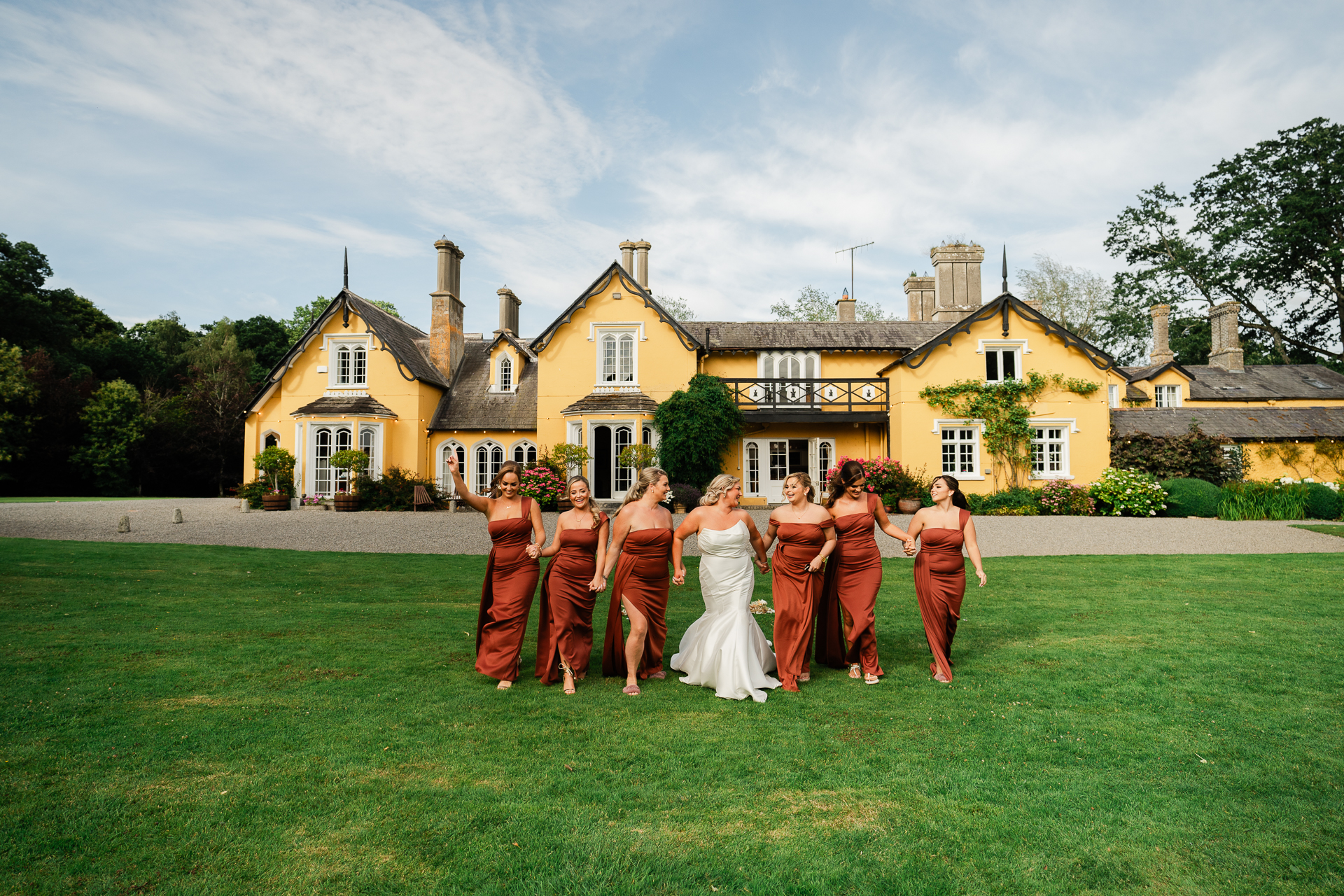 A group of people posing for a photo in front of a house