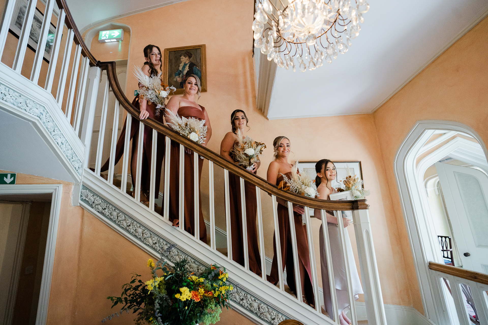 A group of women in white dresses on a staircase