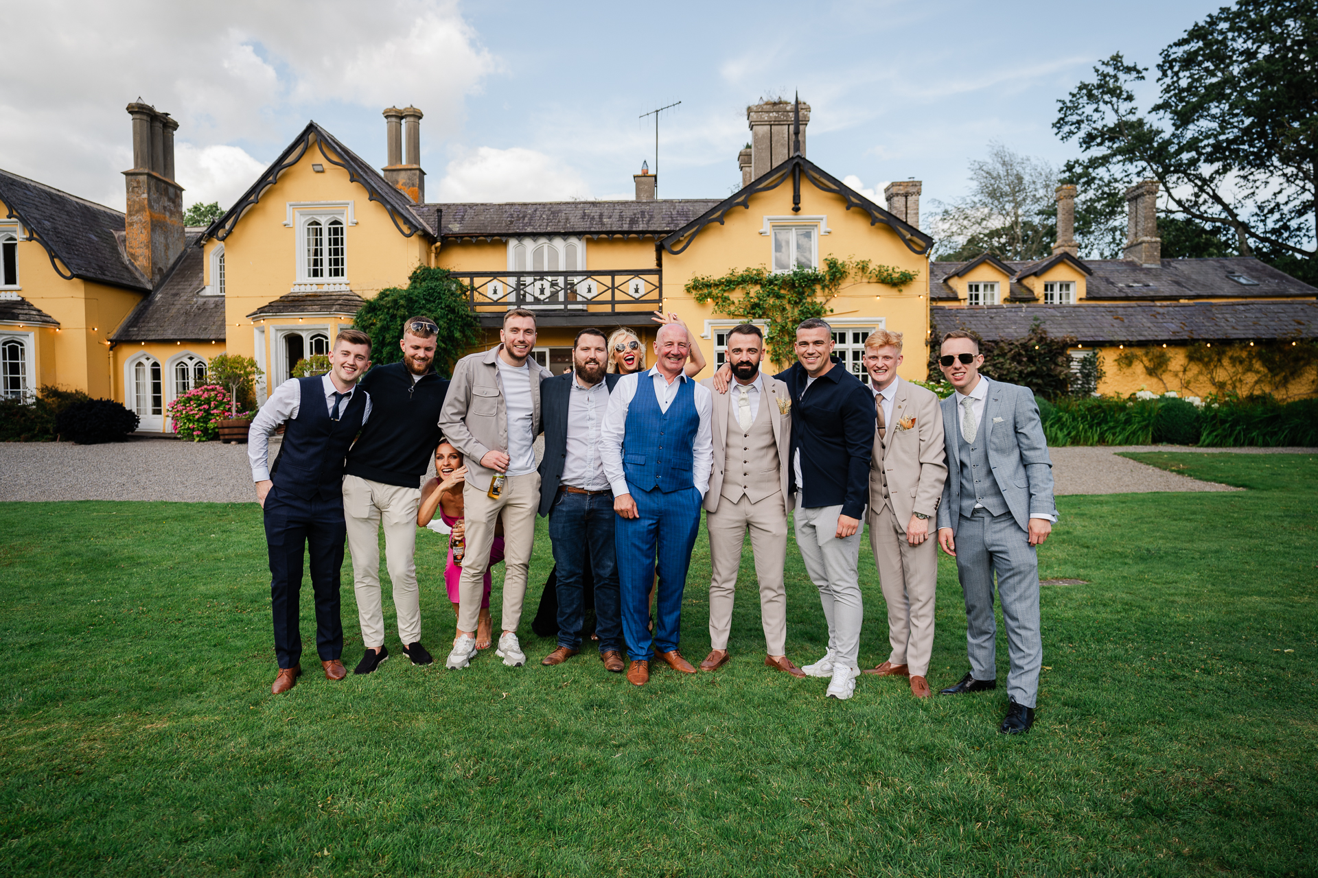 A group of people posing for a photo in front of a house