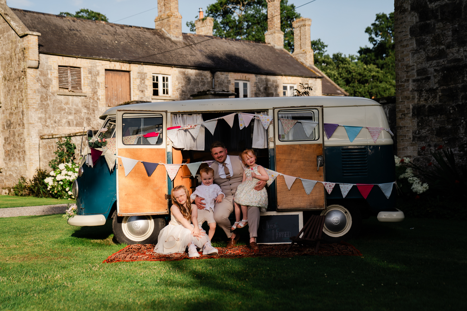 A family posing in front of a van