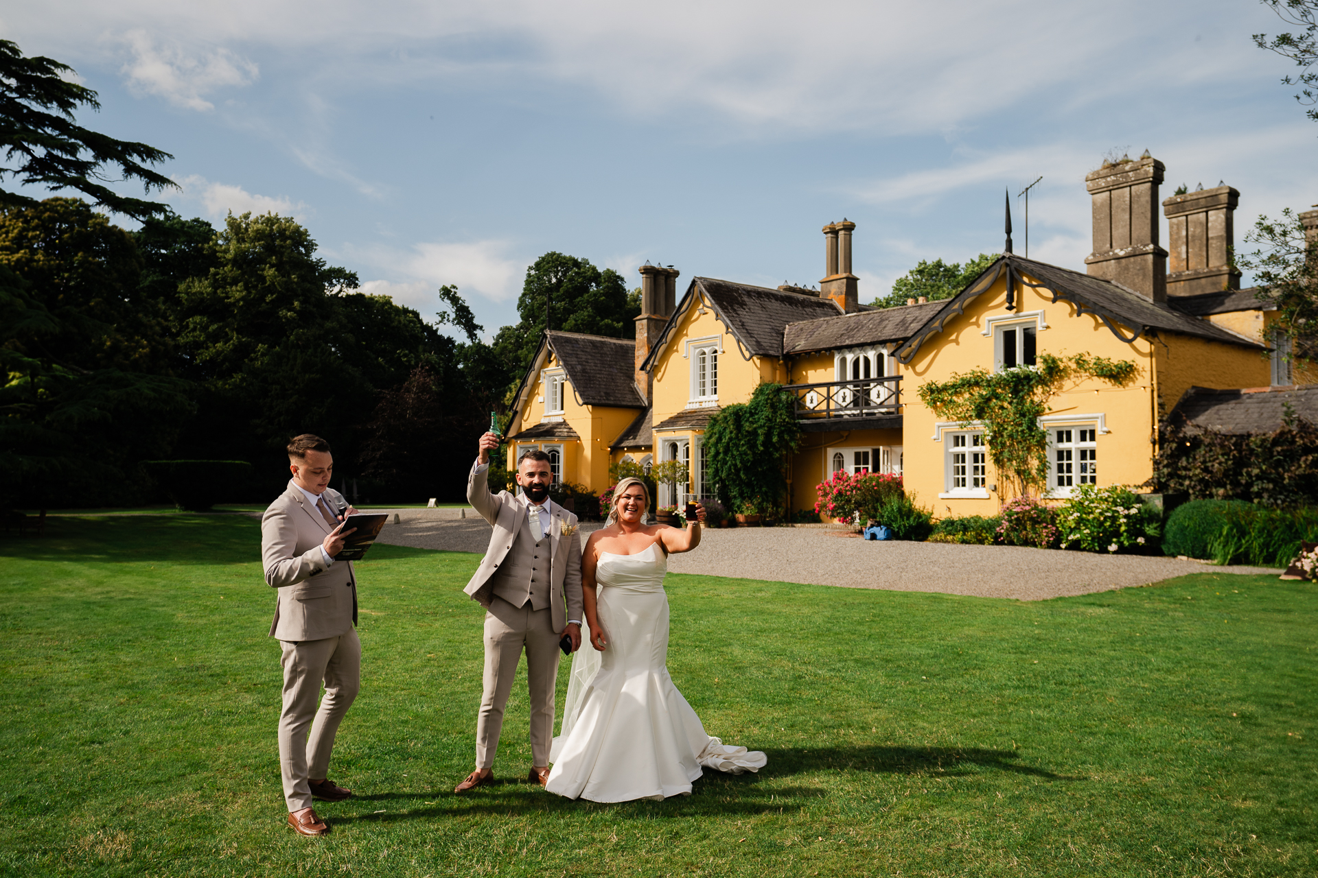 A group of people posing for a picture in front of a house