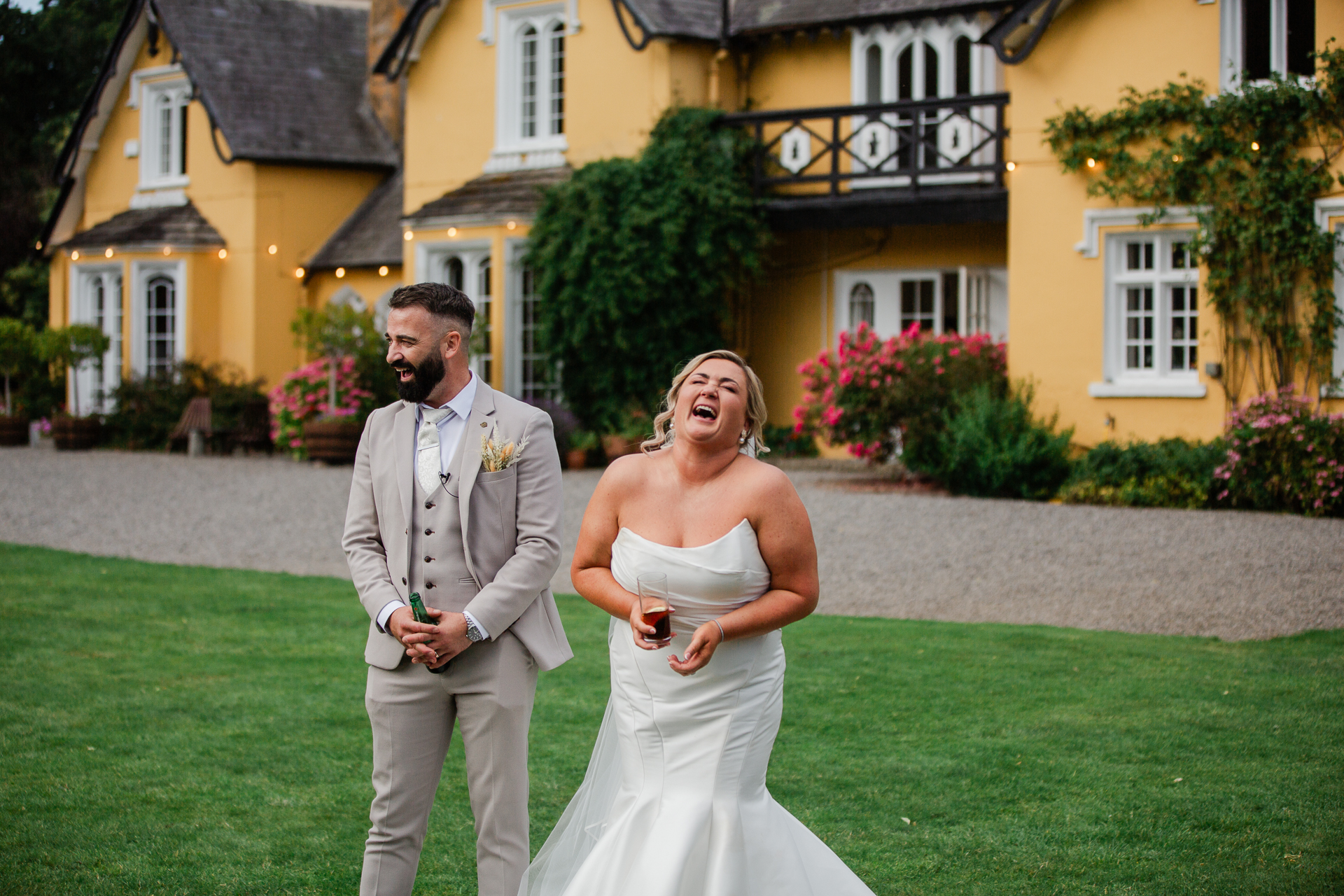 A man and woman posing for a picture in front of a house