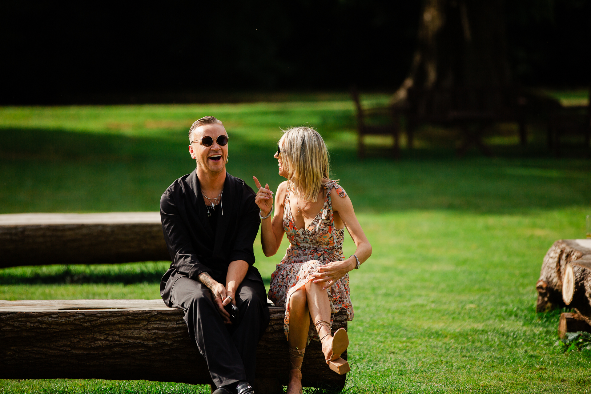 A man and woman sitting on a bench in a park