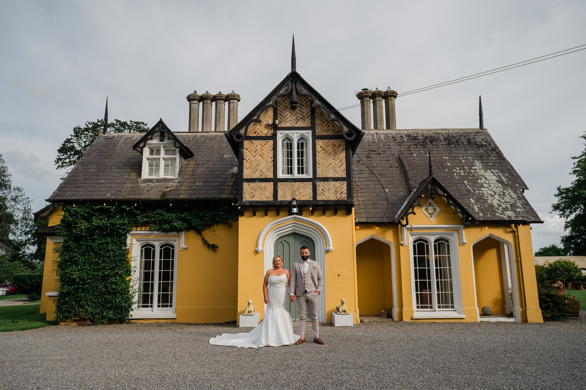 A man and woman standing in front of a house