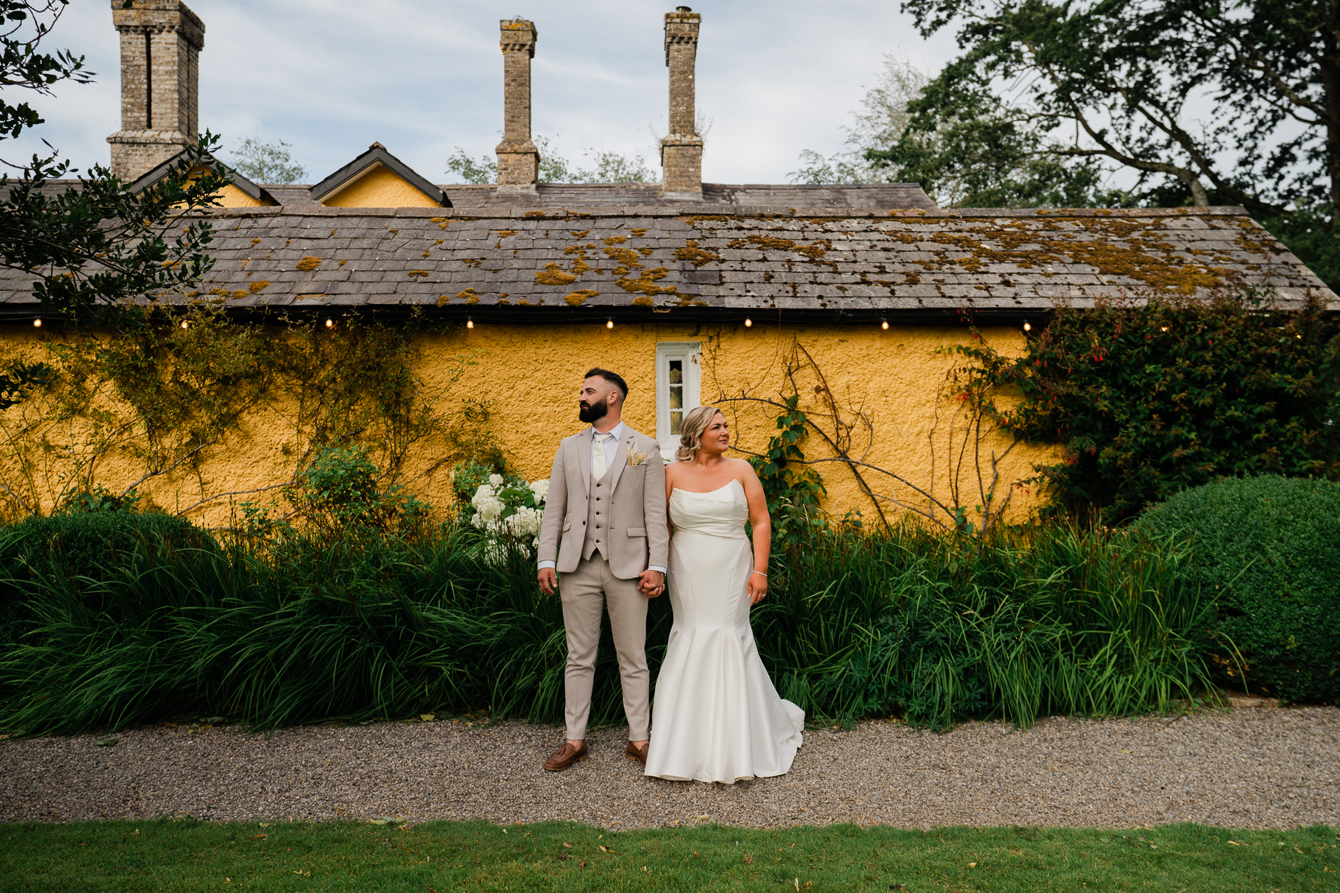 A man and woman posing for a picture in front of a house