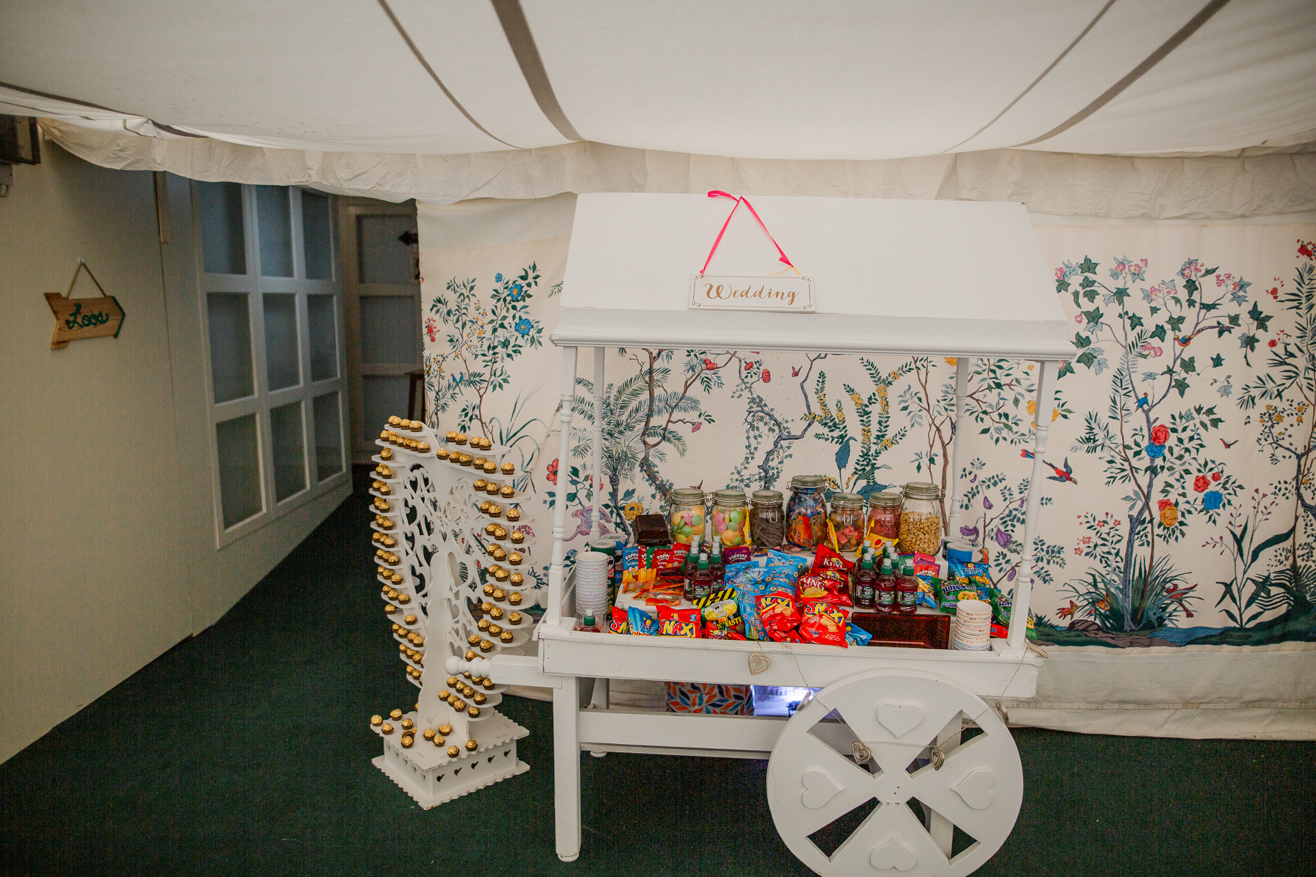 A room with a table and a shelf with objects on it