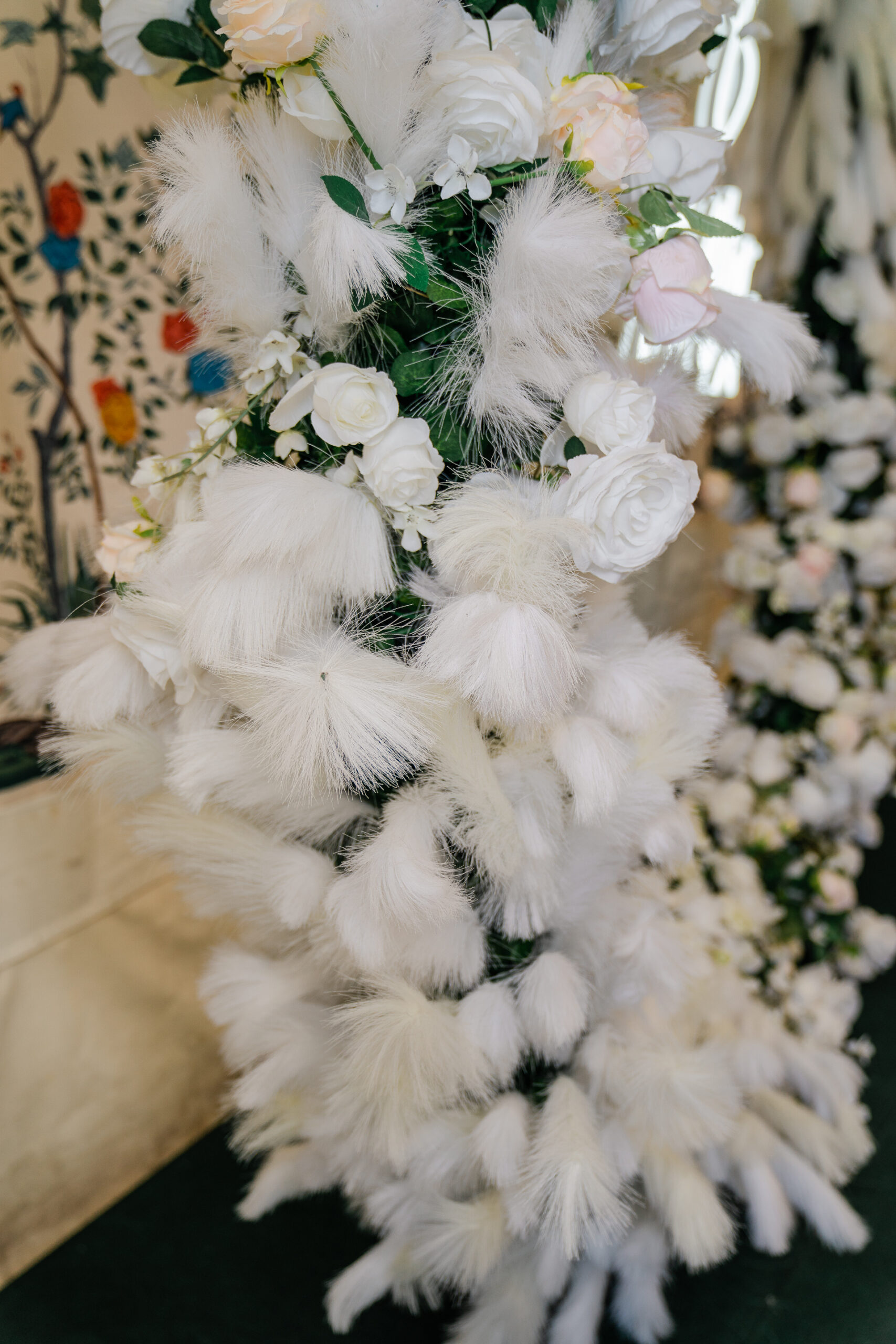 A white furry animal with flowers on it