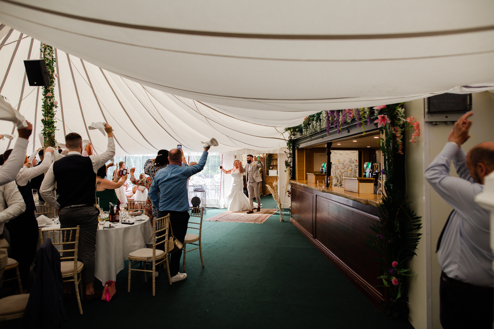 A group of people dancing under a tent