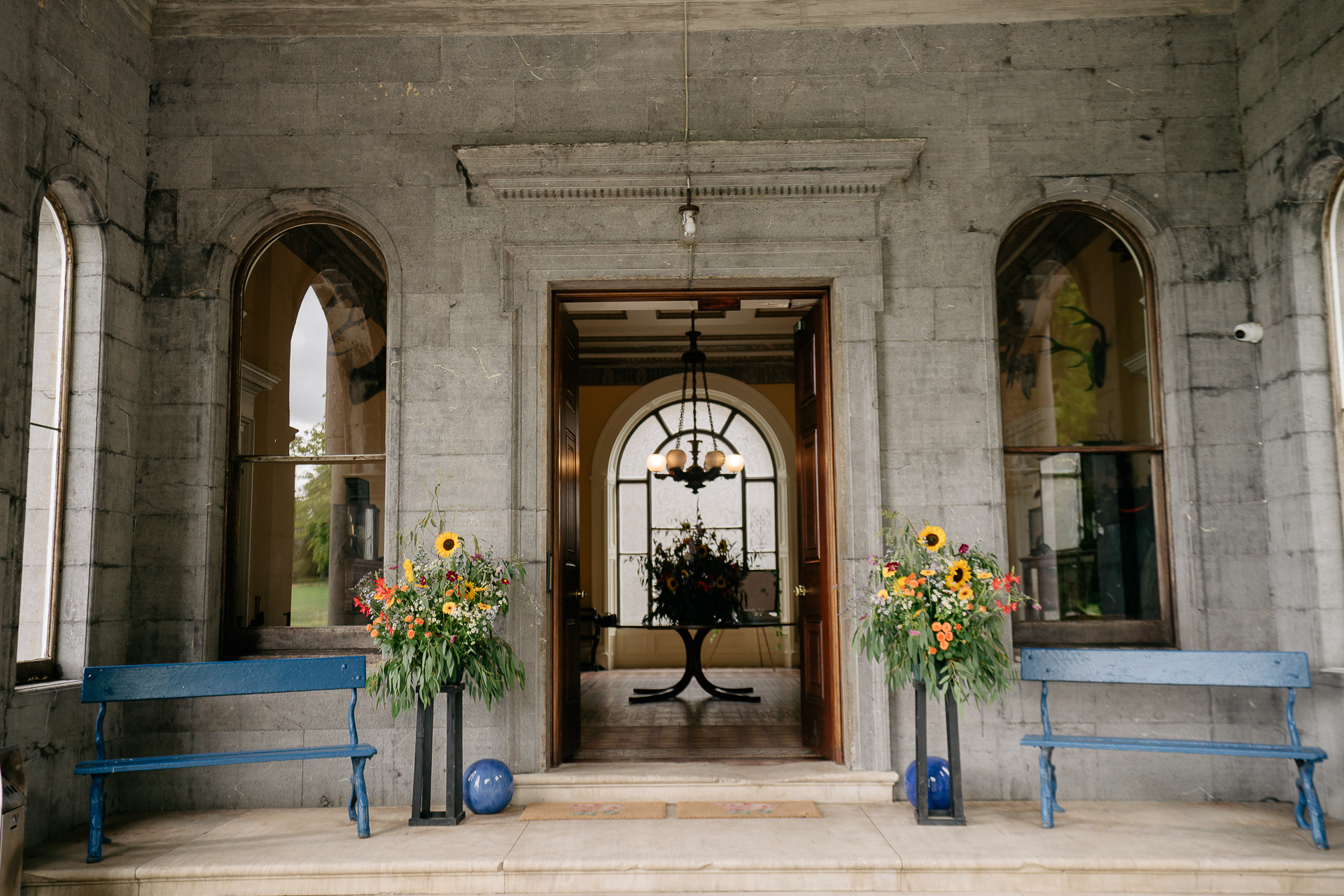 A vase of flowers sits in front of a door