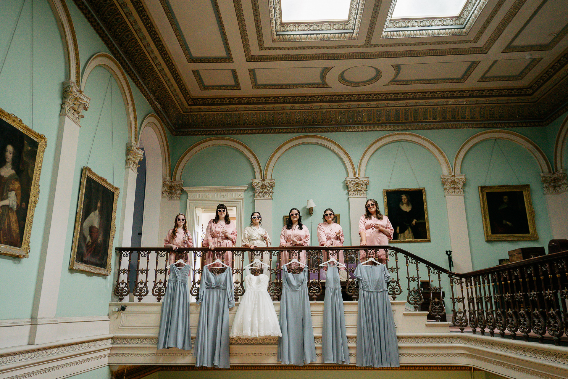 A group of people in robes standing on a staircase