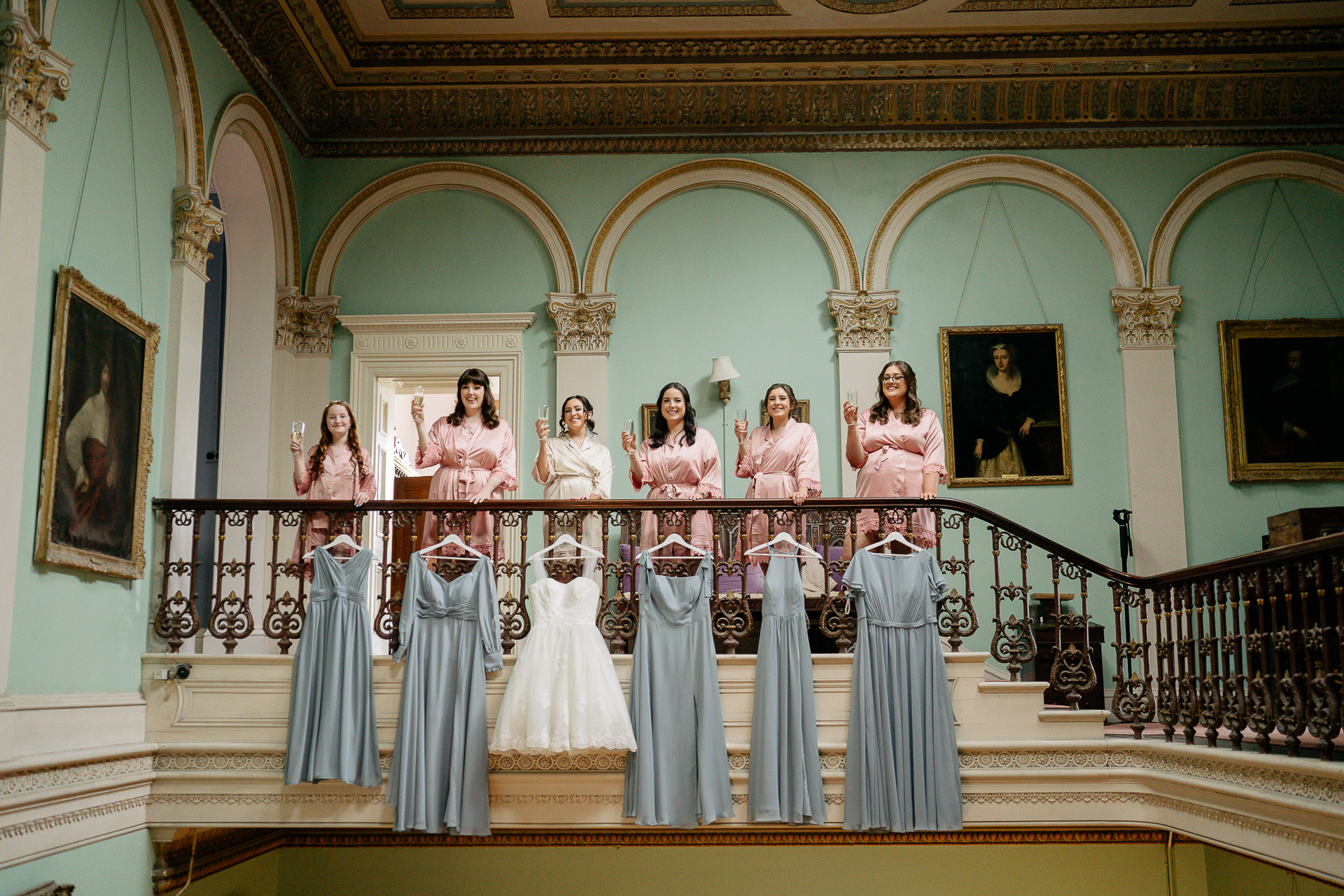 A group of women in dresses on a balcony