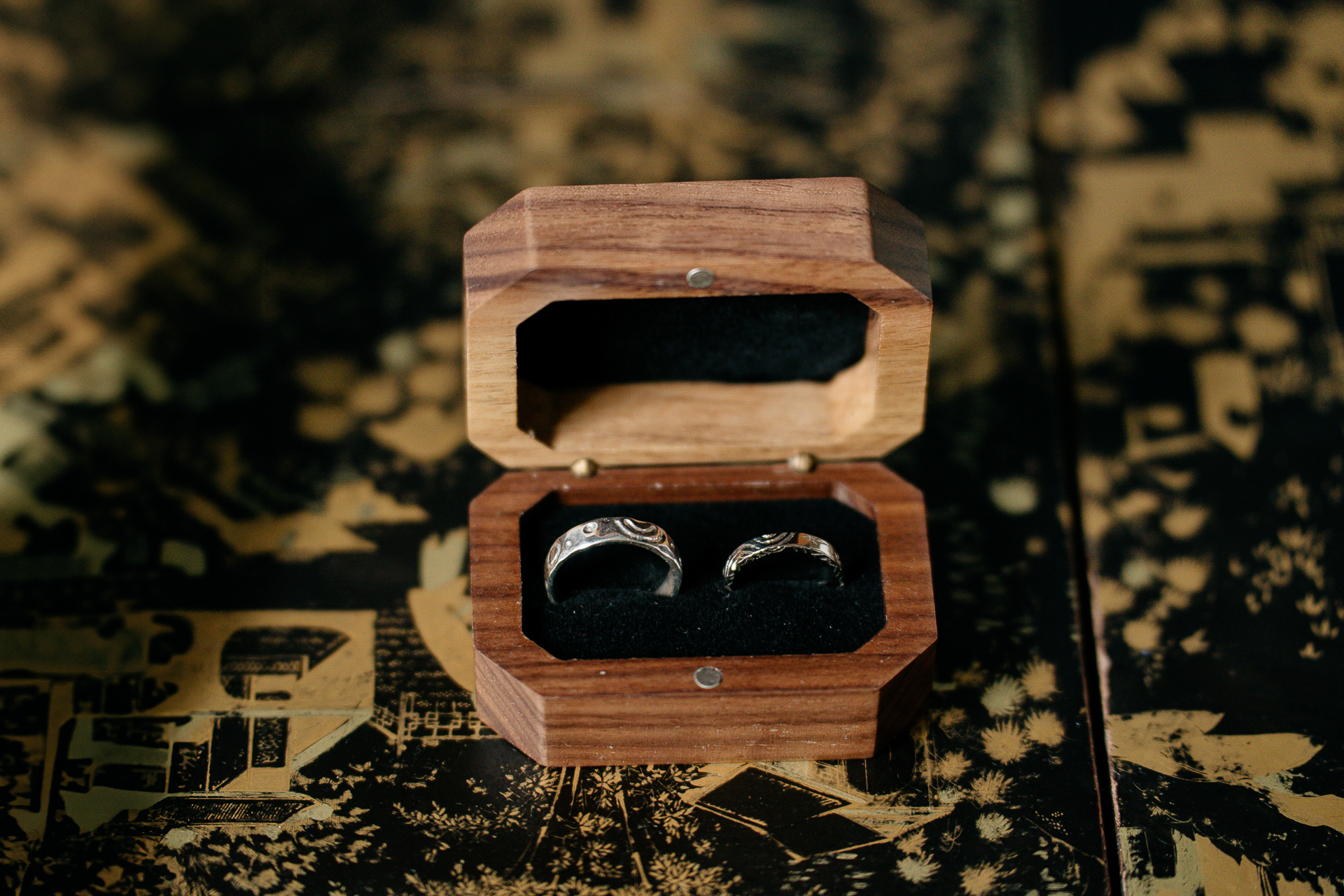 A wooden box with a metal handle