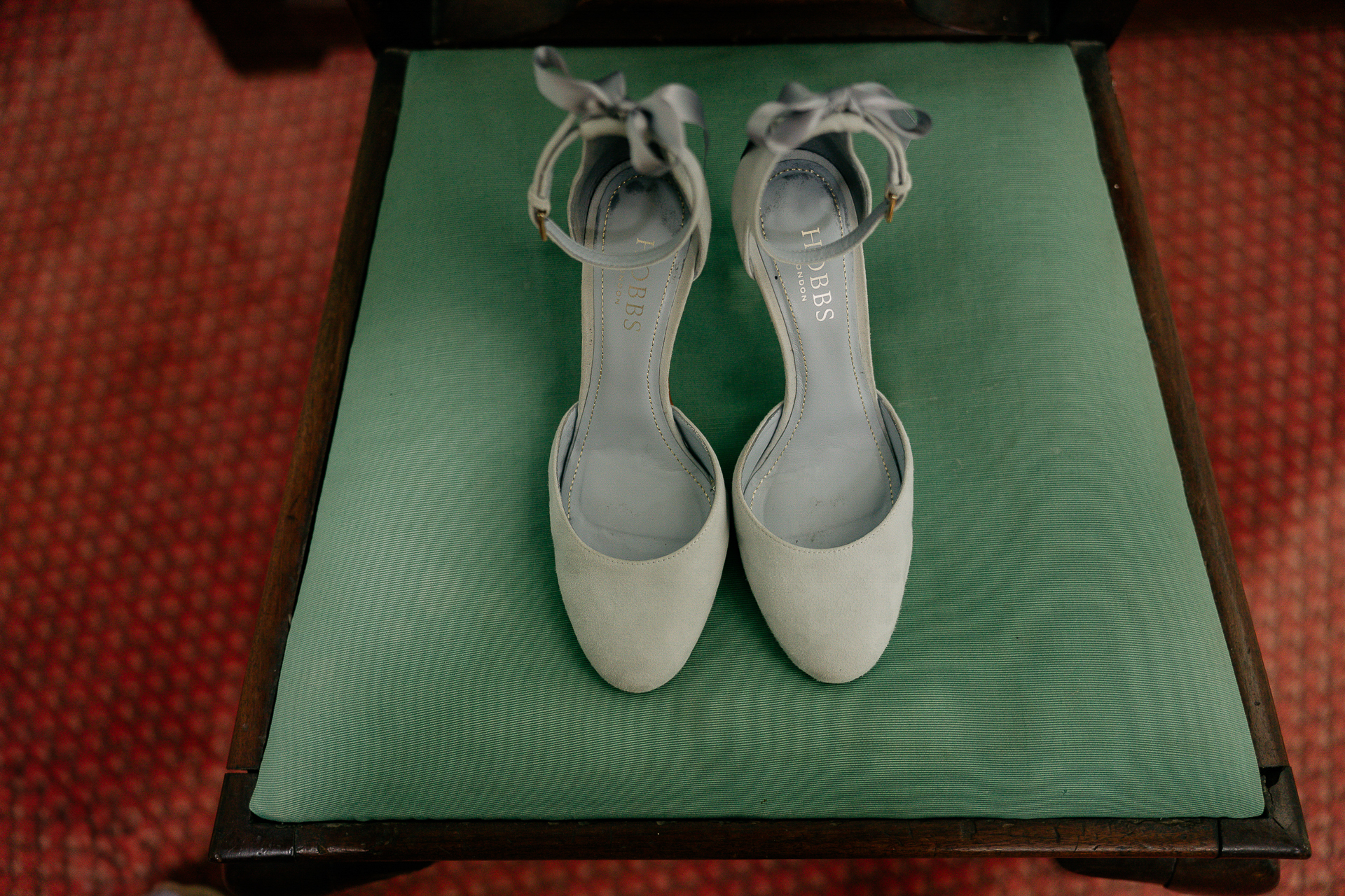 A pair of white shoes on a green box