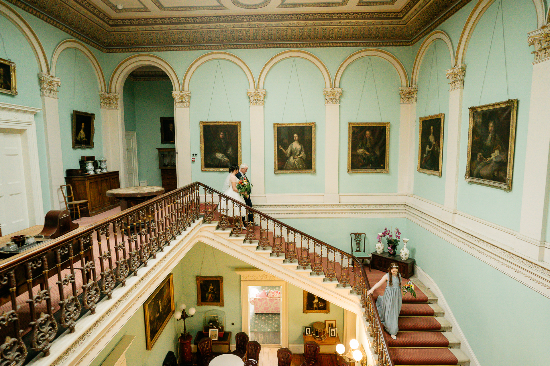 A staircase with paintings on the wall