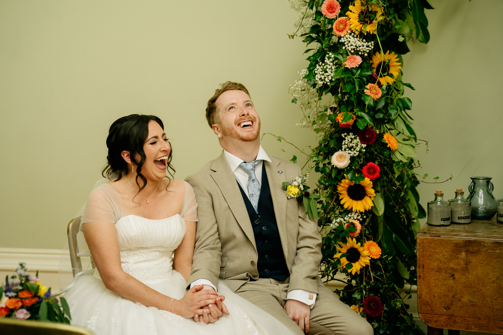 A man and woman sitting next to each other and smiling