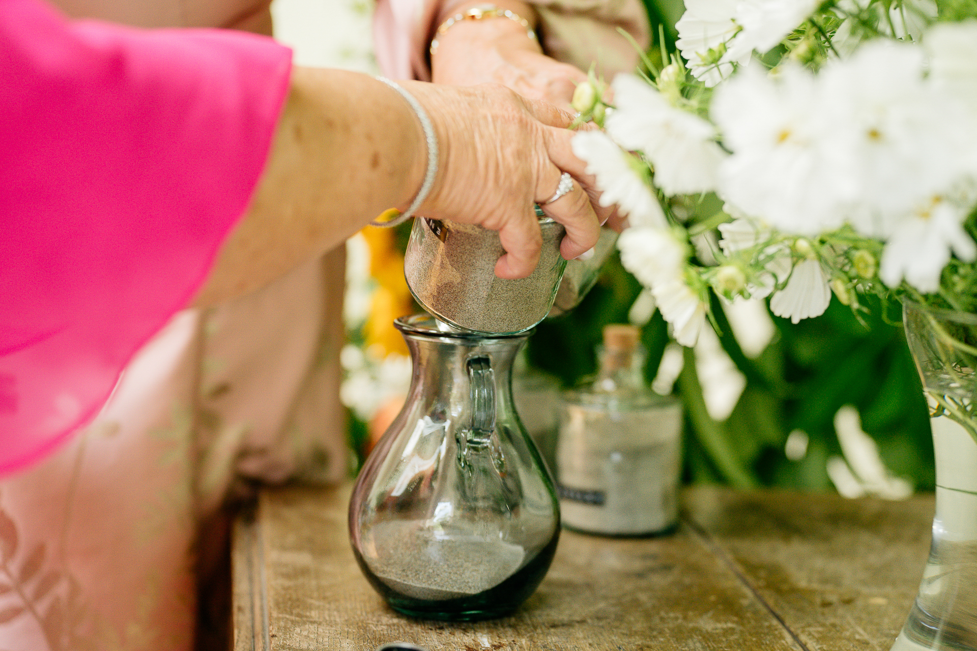 A person pouring a vase of flowers