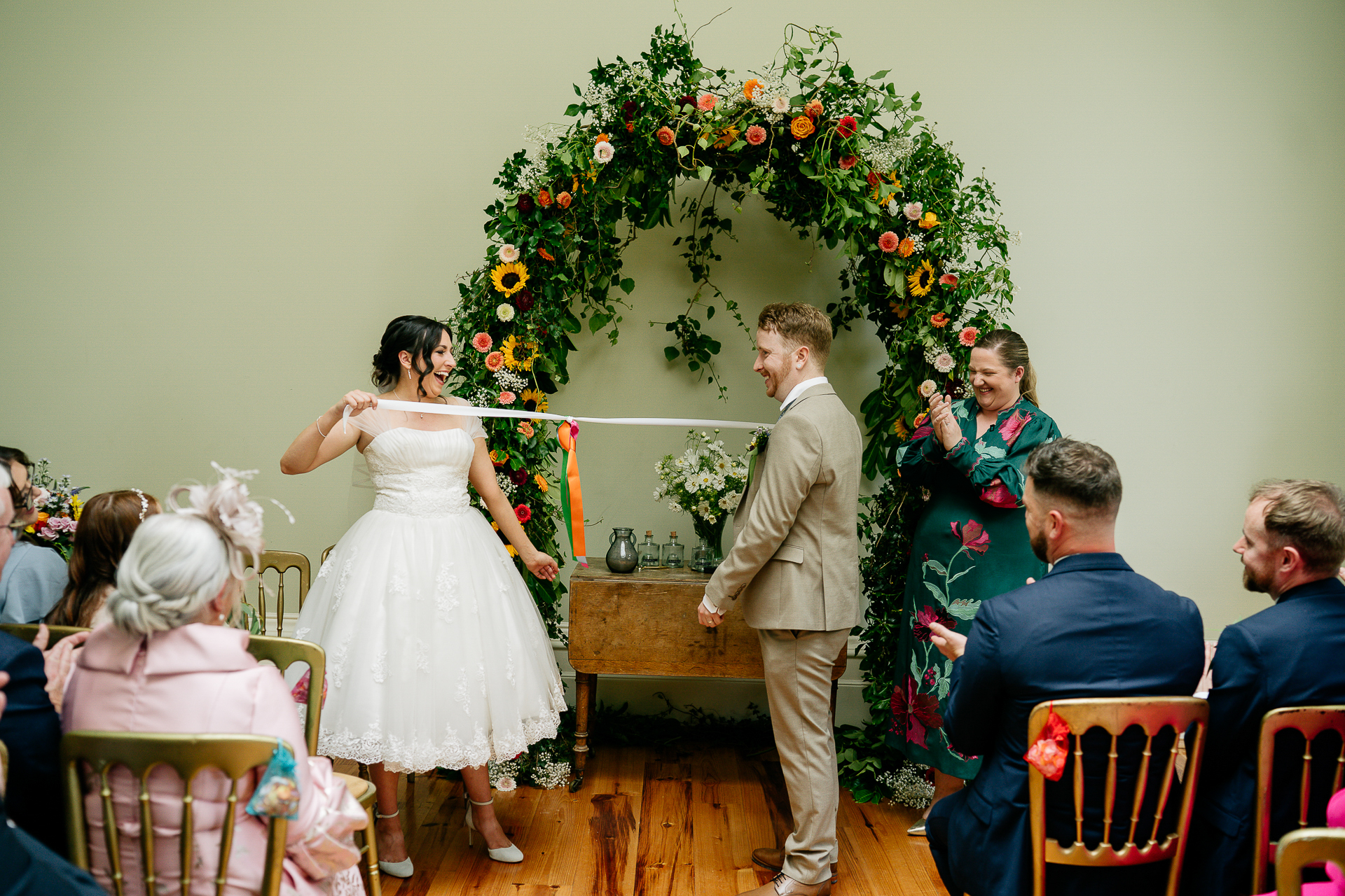 A man and woman walking down a aisle with a woman in a white dress and a man in