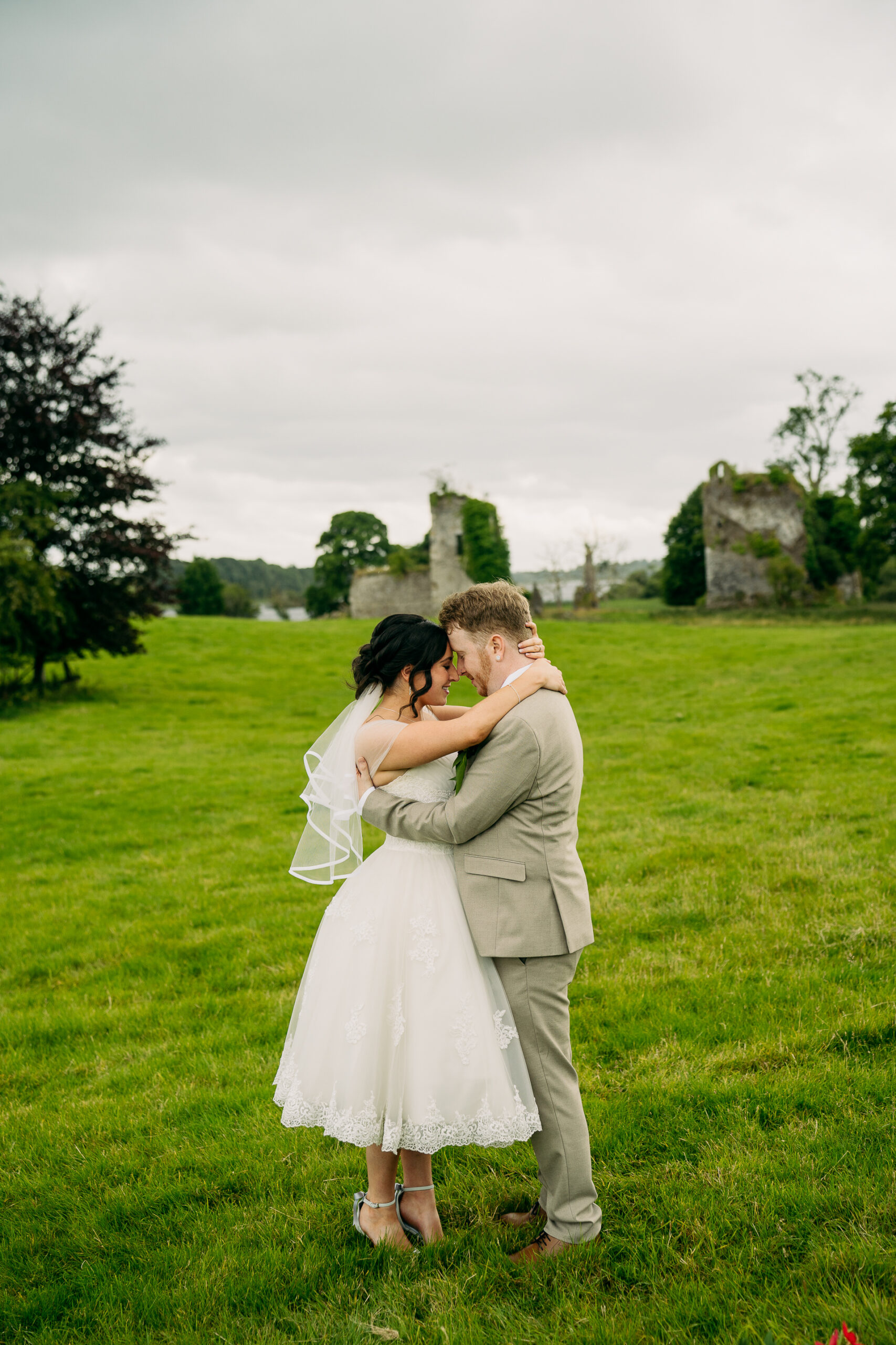 A man and woman kissing in a field