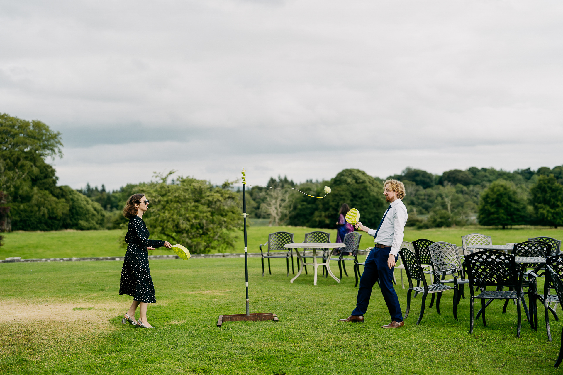 A couple of women playing frisbee in a park